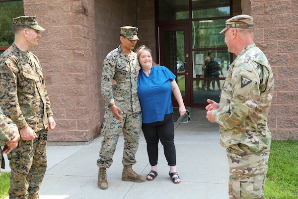 Photo of U.S. Marines with woman thanking them for assisting her during rising flash flood waters