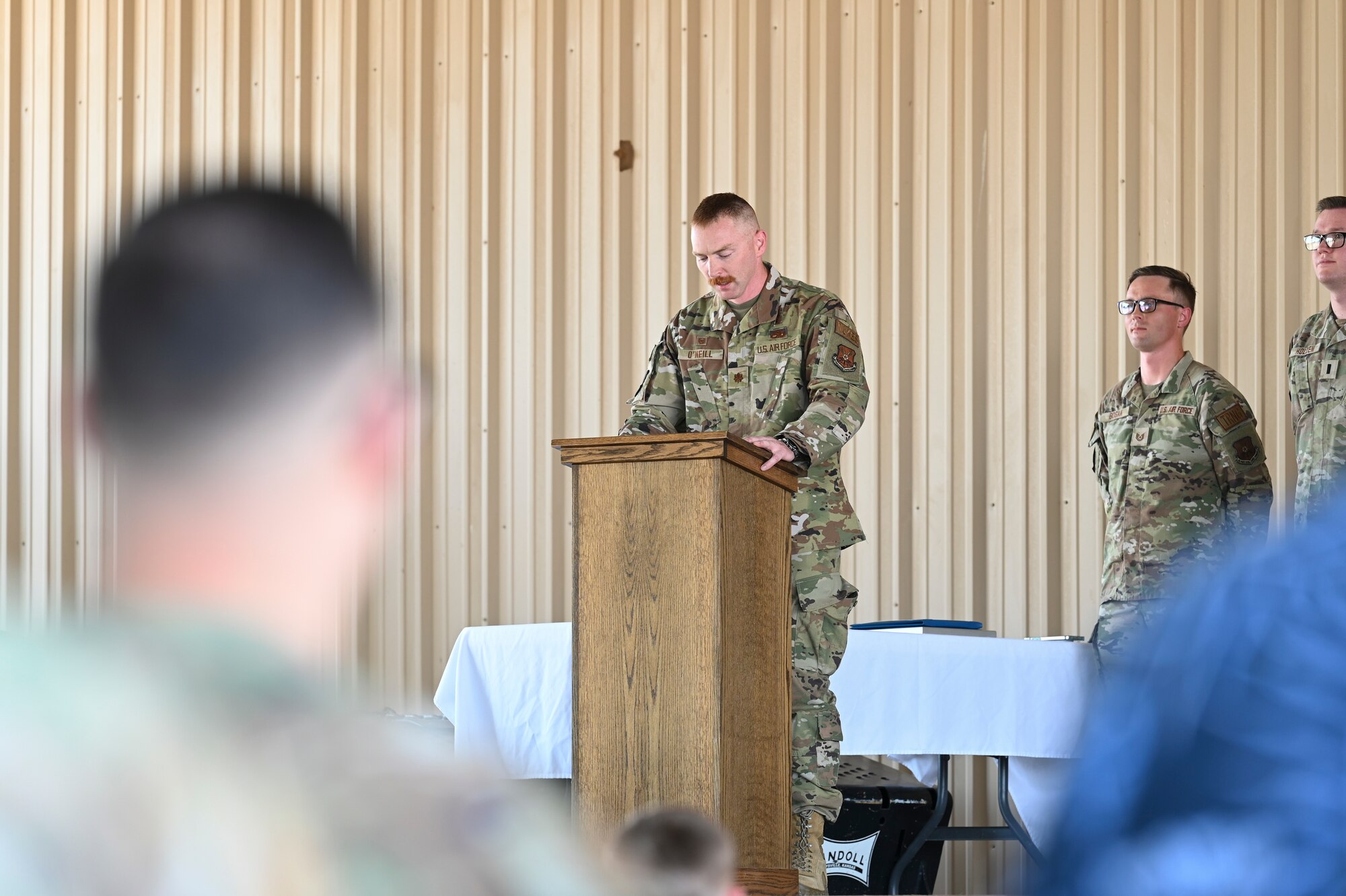 A man speaks at a podium.