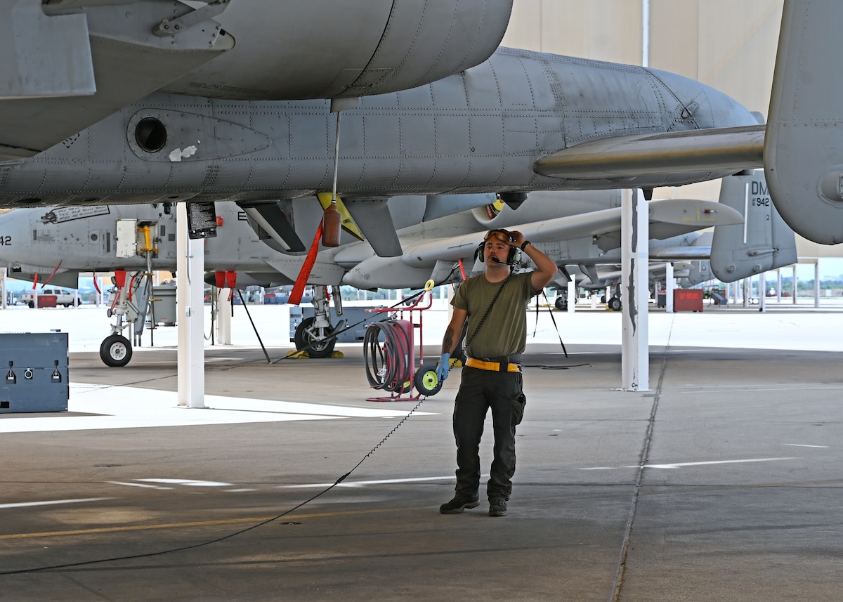 U.S. Air Force Senior Airman Thomas Snyder, 357th Fighter Generation Squadron crew chief, checks the underside of an A-10C Thunderbolt II aircraft at Davis-Monthan Air Force Base, Ariz. July 17, 2023. The A-10 is the Air Force's premier ground attack platform. (U.S. Air Force photo by Staff Sgt. Abbey Rieves)