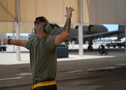 U.S. Air Force Senior Airman Thomas Snyder, 357th Fighter Generation Squadron crew chief, marshalls in an A-10C Thunderbolt II aircraft as it taxis onto the flightline at Davis-Monthan Air Force Base, Ariz. July 17, 2023. Snyder has been a crew chief at DM for three years. (U.S. Air Force photo by Staff Sgt. Abbey Rieves)
