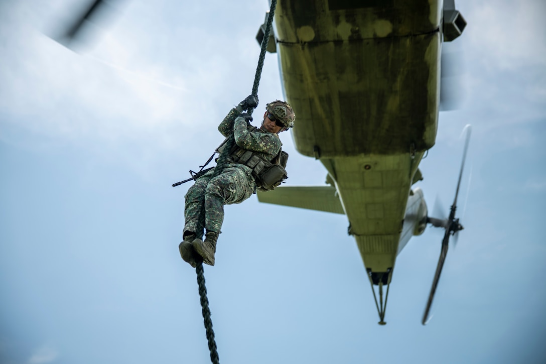 A Philippine Marine with Battalion Landing Team 4 fast-ropes from a CH-53E Super Stallion attached to Marine Heavy Helicopter Squadron 462 during Marine Aviation Support Activity 23 at Naval Education, Training and Doctrine Command, Philippines, July 12, 2023. MASA is a bilateral exercise between the Armed Forces of the Philippines and the U.S. Marine Corps, aimed at enhancing interoperability and coordination focused on aviation-related capabilities. During MASA 23, Armed Forces of the Philippines and U.S. Marines conduct approximately twenty different training evolutions, including live-fire, air assaults, and subject matter expert exchanges across aviation, ground, and logistics capabilities.