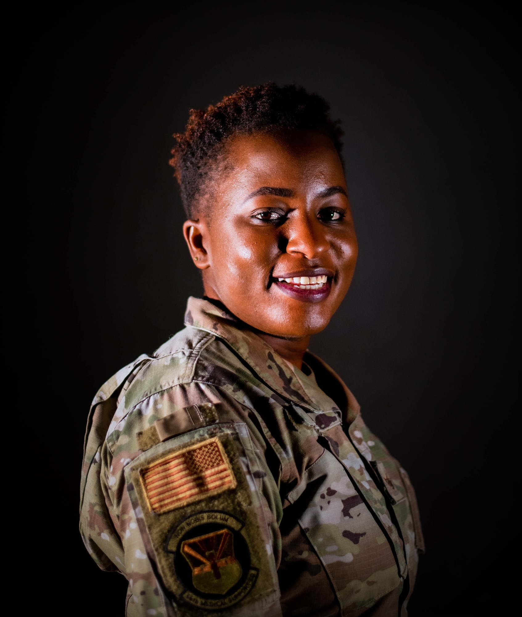 U.S. Air Force Staff Sgt. Winnie Adipo, 56th Medical Group noncommissioned officer in charge of personnel administration, poses for a studio photo.