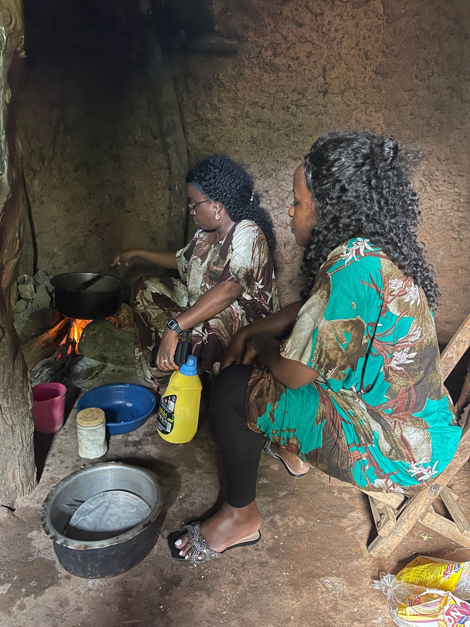 Winnie Adipo (right), cooks lunch with her sister, Idza Adipo.