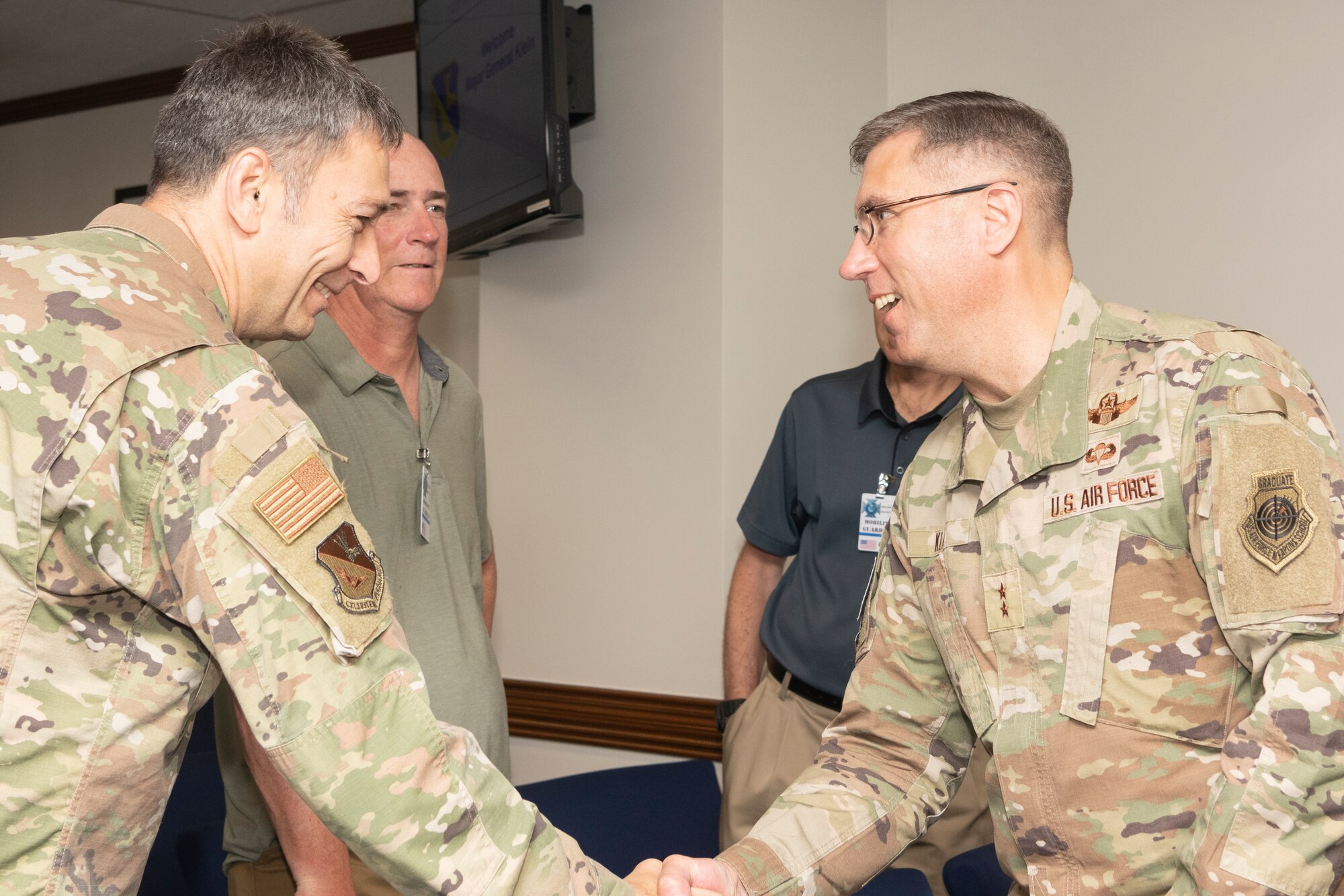Two soldiers shake hands in greeting