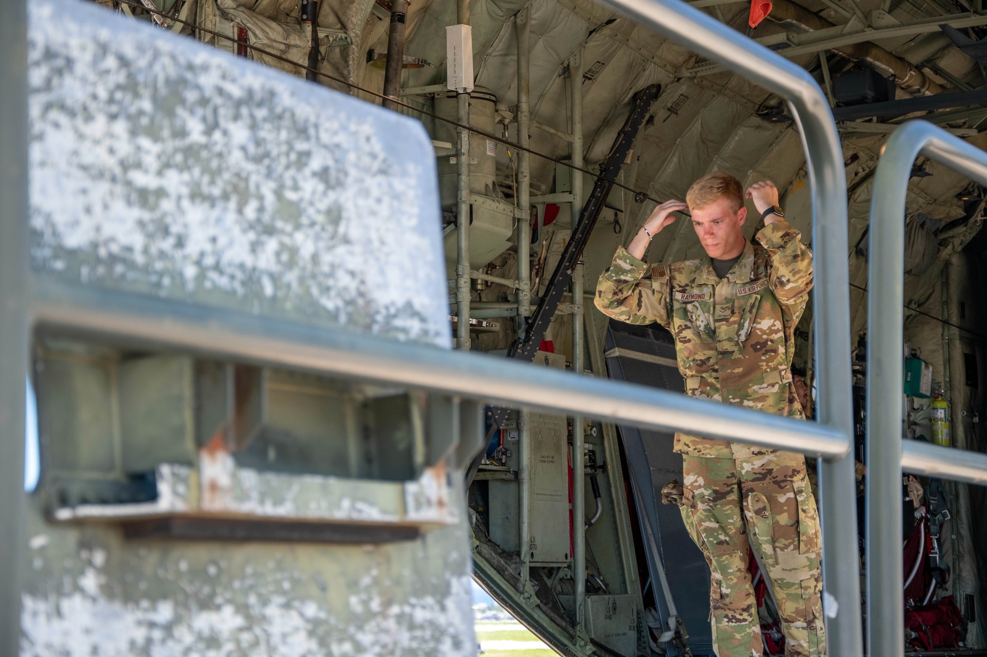 An Airman marshals a cargo loading vehicle.