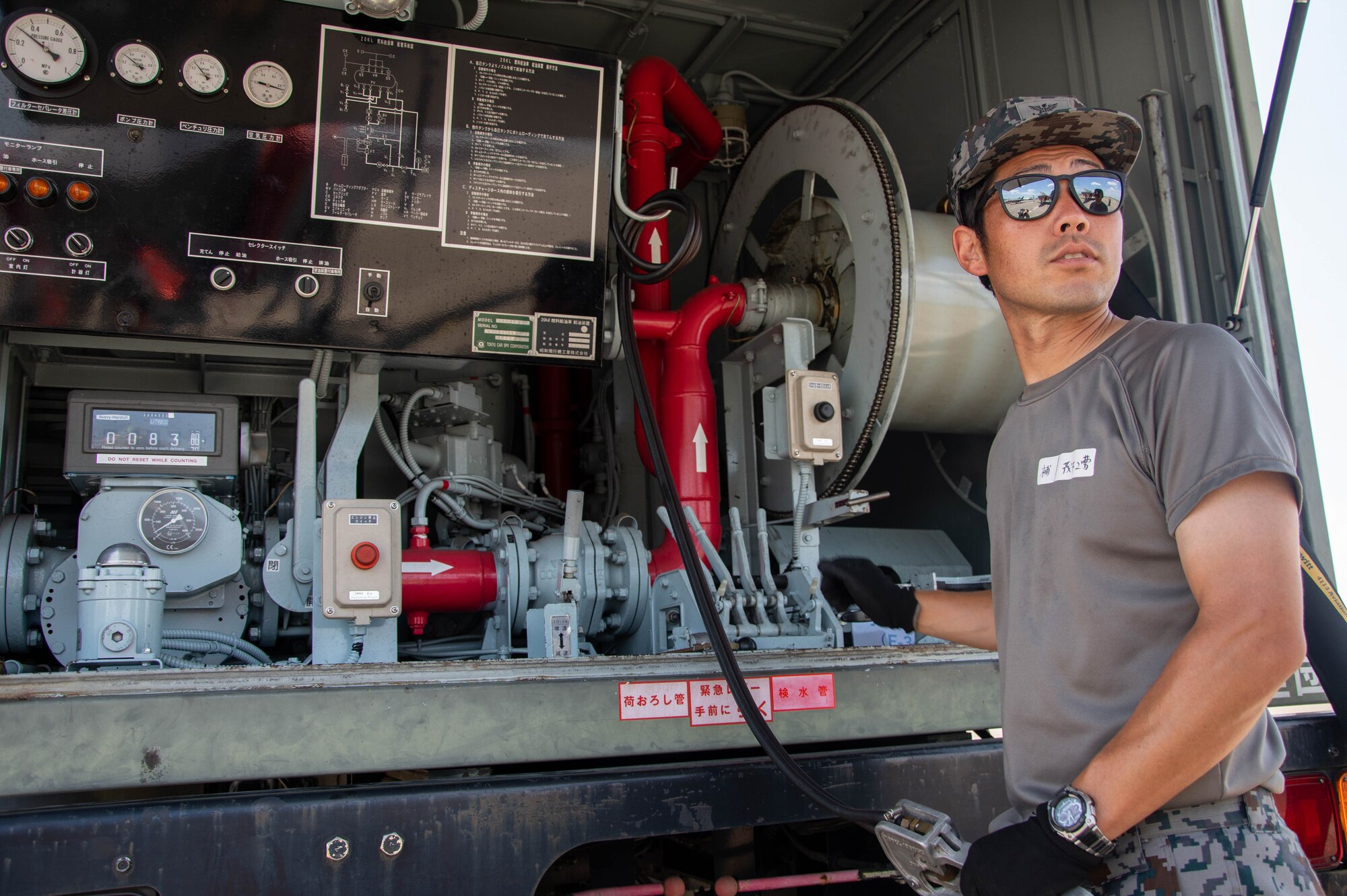 A JASDF member conducts a hot-pit refuel.