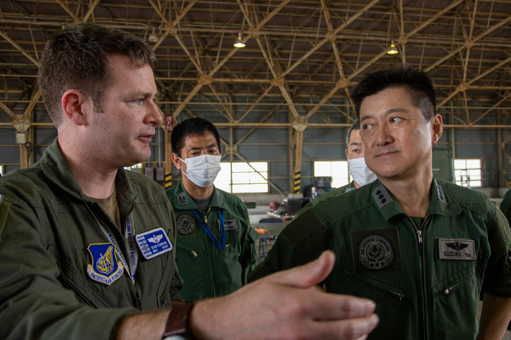USAF and JASDF members discuss operations.