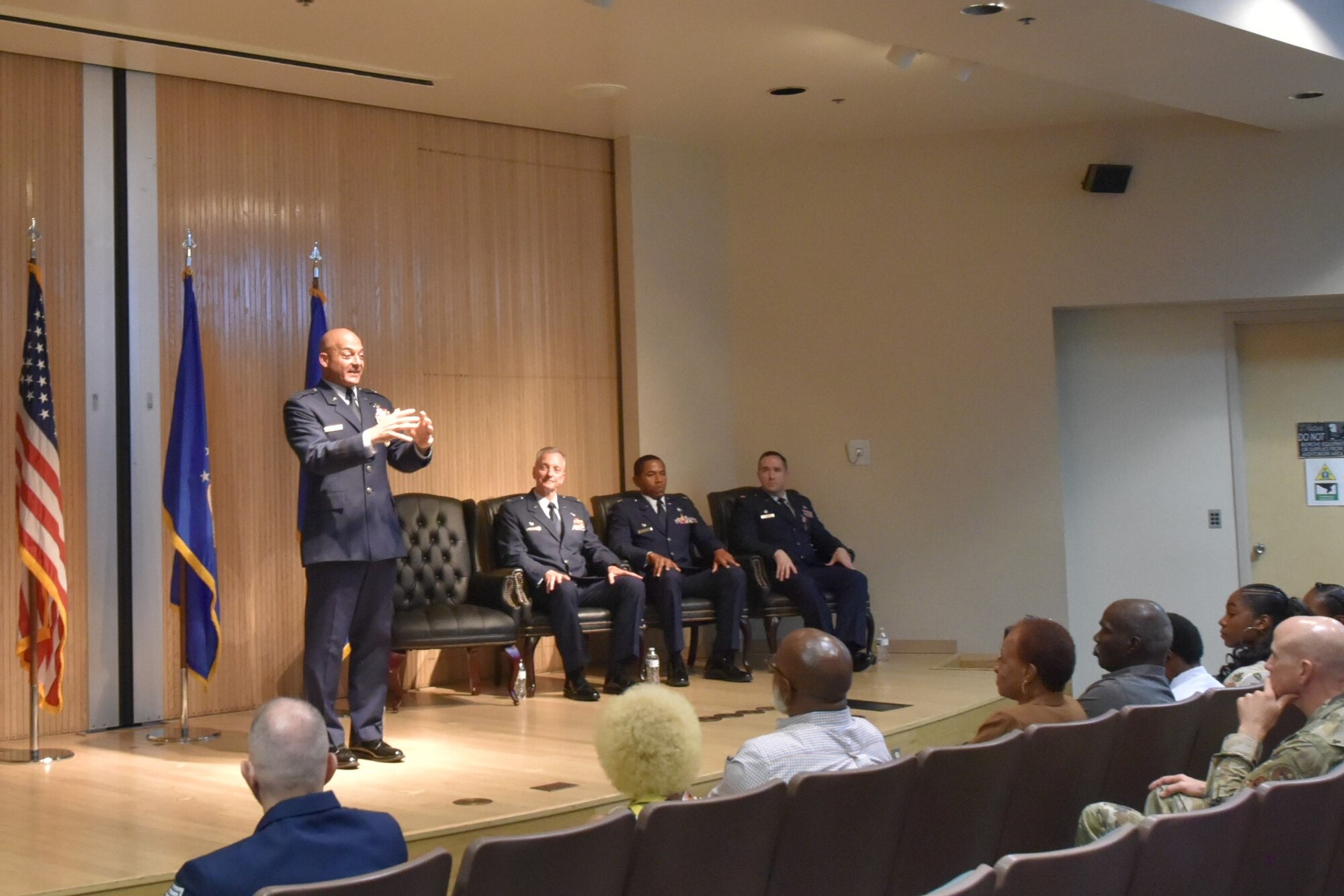 U.S. Air Force Brig. Gen. George Dietrich III addresses the audience as Col. Terry Koester, Maj. W. Frank Larkins, and Maj. Devin Taber listen during the 982d MXS inactivation and 82d TRSS activation ceremony.