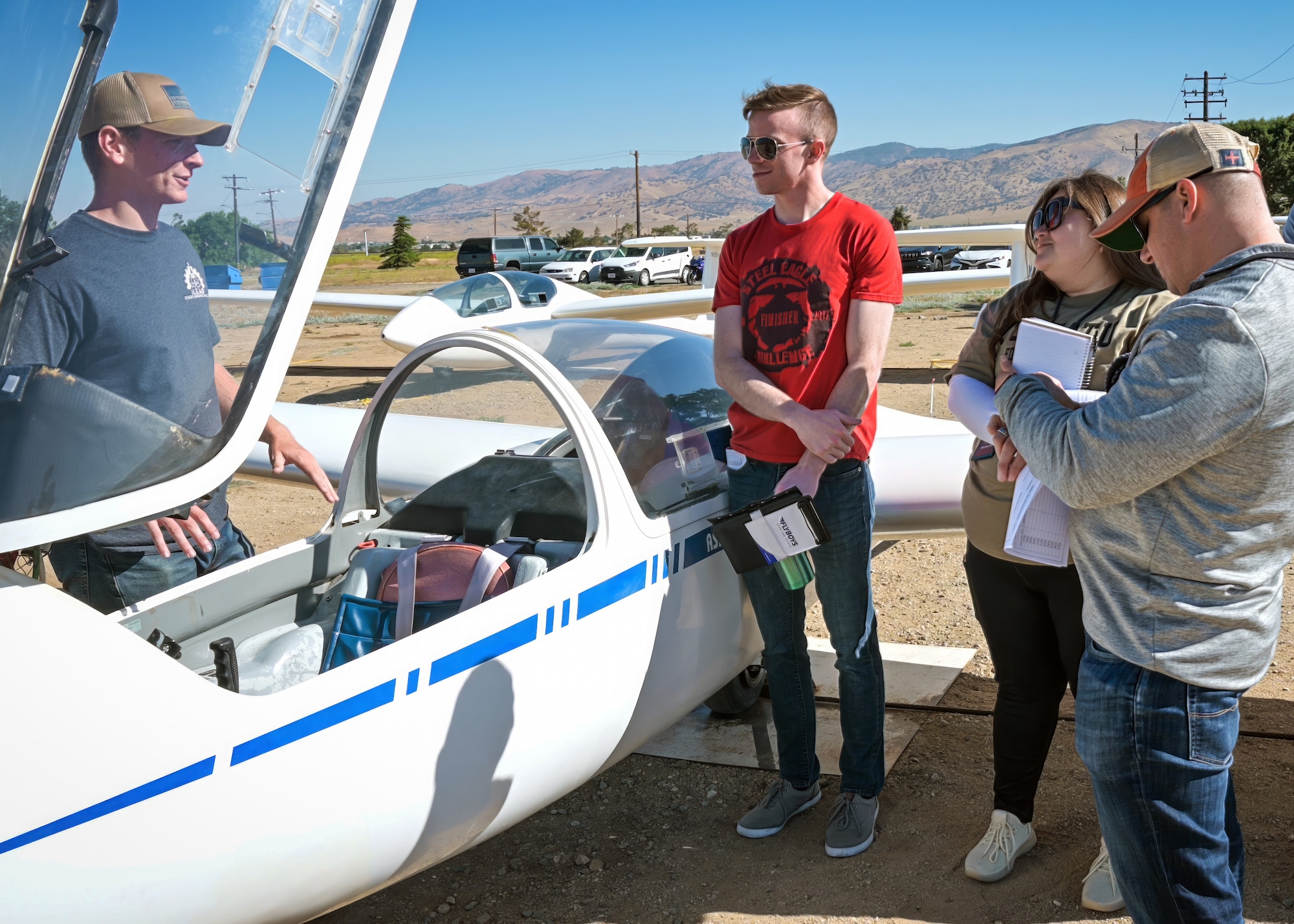 A group of 412th Test Wing personnel receive a pre-flight brief on a glider during inaugural Glider Orientation Program class at Mountain Valley Airport, Tehachapi, June 22. The program is designed to better integrate and immerse newer engineers into the Edwards Air Force Base flight test mission. (Air Force photo by Giancarlo Casem)