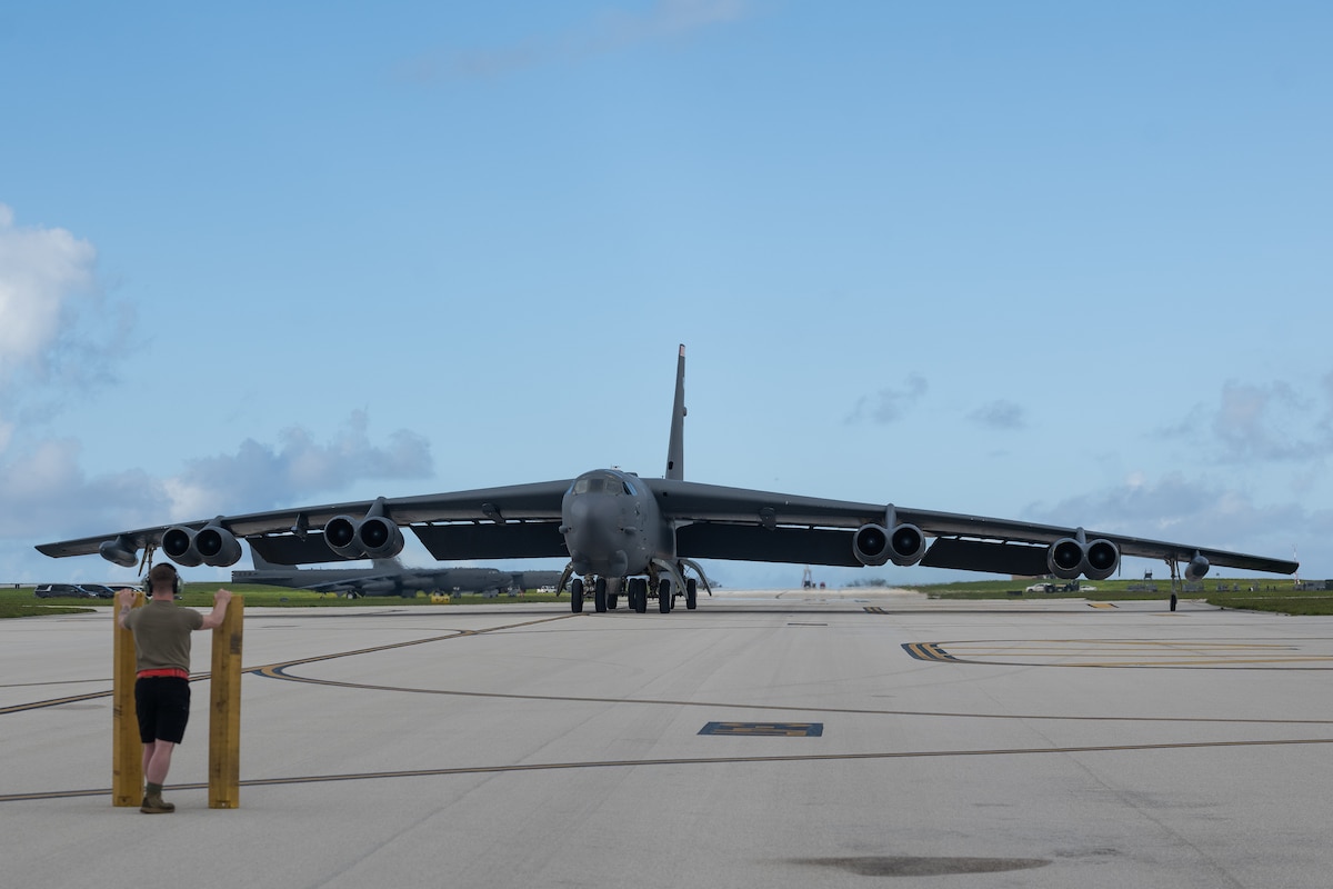 A U.S. Air Force crew chief assigned to the 5th Aircraft Maintenance Squadron watches a U.S. Air Force B-52H Stratofortress assigned to the 23rd Expeditionary Bomb Squadron as it taxis on the runway in preparation for post-flight procedures following a flight in support of a Bomber Task Force deployment at Andersen Air Force Base, Guam, June 15, 2023. U.S. Strategic Command regularly tests and evaluates the readiness of strategic assets such as the B-52 to ensure extended deterrence commitments are strong and credible. (U.S. Air Force photo by Tech. Sgt. Zade Vadnais)