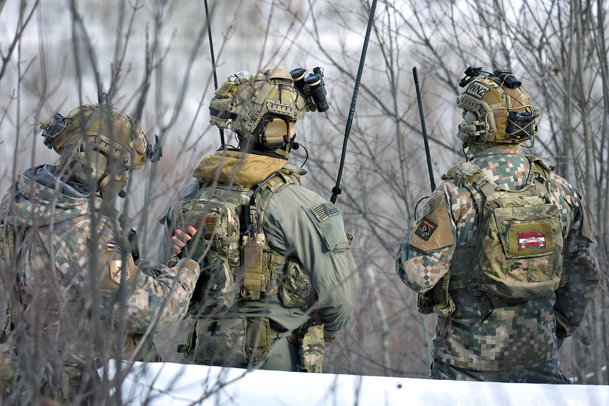 Military personnel from the Latvian National Armed Forces work side-by-side with U.S. Army Soldiers assigned to Battery C, 1st Battalion, 120th Field Artillery Regiment, Wisconsin Army National Guard, while conducting close air support training during Northern Strike 22-1 (“Winter Strike”) at the National All-Domain Warfighting Center, Grayling, Mich., Jan. 27, 2022.