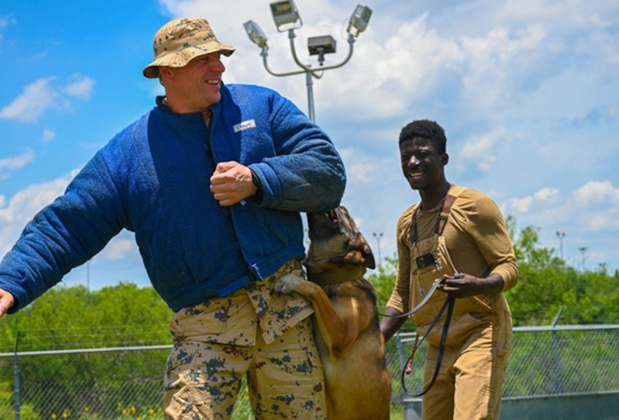 1st Lt. Martti Eerma, a Estonian Defense Force reservist, is attacked while wearing padded protective clothing by a military working dog as part of a training demonstration guided by Staff Sgt. Wilson Brantley, 802nd Security Forces Squadron, a military working dog trainer, at Joint Base San Antonio-Medina Annex, Texas, June 8, 2023. Eerma visited the installation as part of the Military Exchange program coordinated with NATO militaries to help develop cultural understanding, regional expertise, language proficiency, and interoperability. (U.S. Air Force photo by Senior Airman Mark Colmenares)