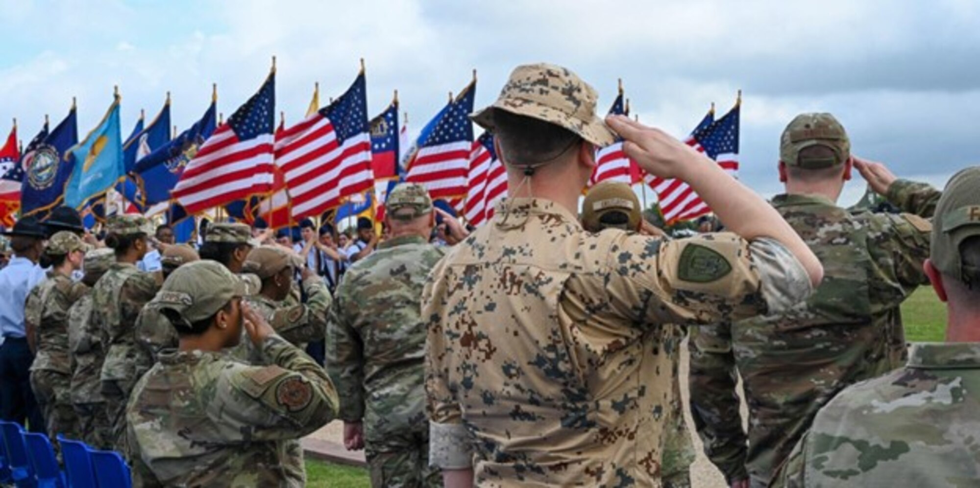 1st Lt. Martti Eerma, a reservist from the Estonia Defense Force, salutes the passing of each of the U.S. flags as part of customs and courtesies during the Graduation Parade at Basic Military Training graduation, Joint Base San Antonio - Lackland, Texas, June 1, 2023. Eerma visited the installation as part of the Military Exchange program coordinated with NATO militaries to help develop cultural understanding, regional expertise, and language proficiency and interoperability. (U.S. Air Force photo by Staff Sgt. Adriana Barrientos)