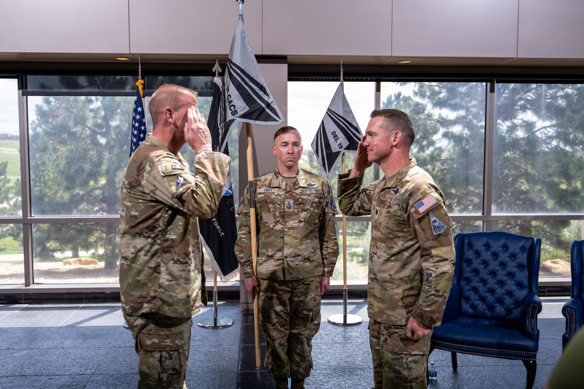 Two men in uniform salute each other