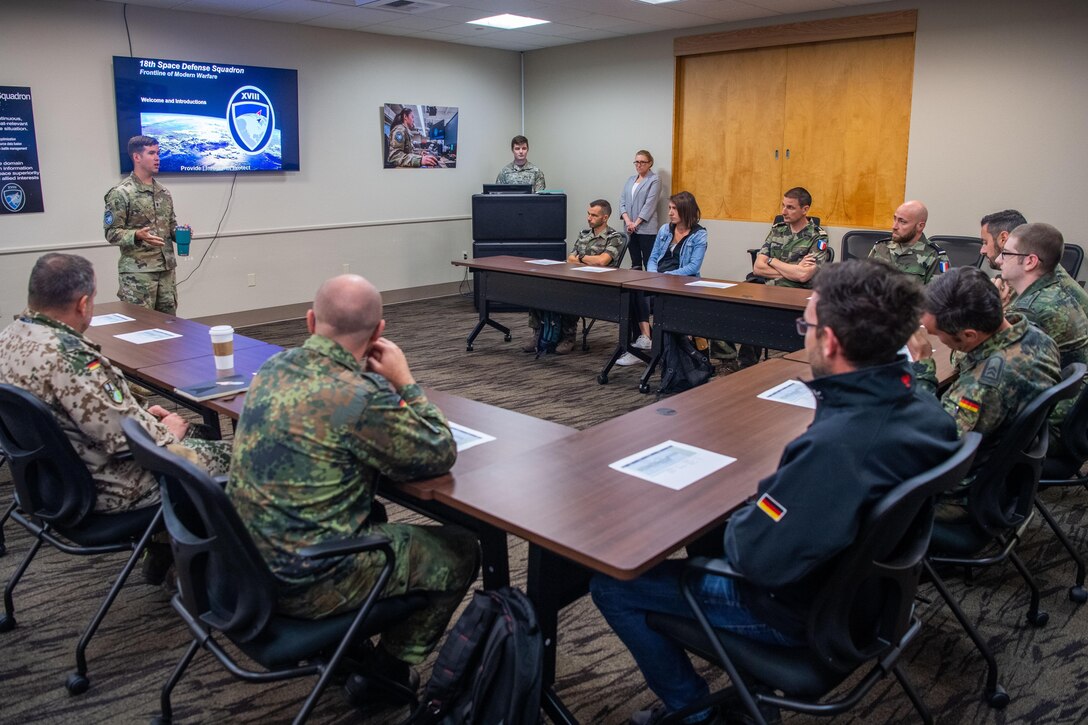 U.S. Space Force Lt. Col. Jordan O.E. Mugg, commander, 18th Space Defense Squadron, welcomes members from the German Space Situational Awareness Centre and Operational Center for Military Surveillance of Space Objects during a German-French operator exchange at Vandenberg Space Force Base, Calif., July 10, 2023. During this exchange, participants exchanged common practices and best practices, shared their unique mission capabilities, and explained their methodologies and underlying technologies. (U.S. Space Force photo by Julian Labit)