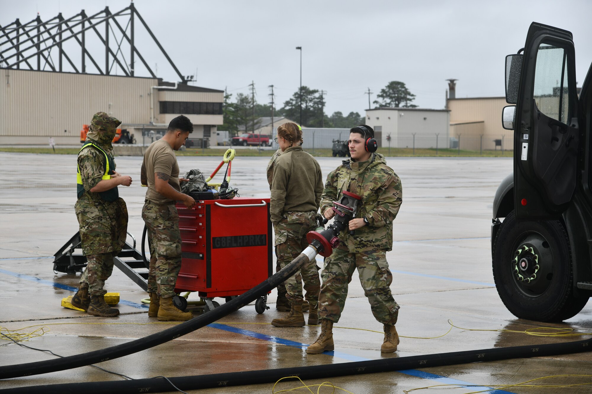A photo of Airman Gabriel Sotelo pulling an R-11 Refueler hose away from an F-16 fighting Falcon.