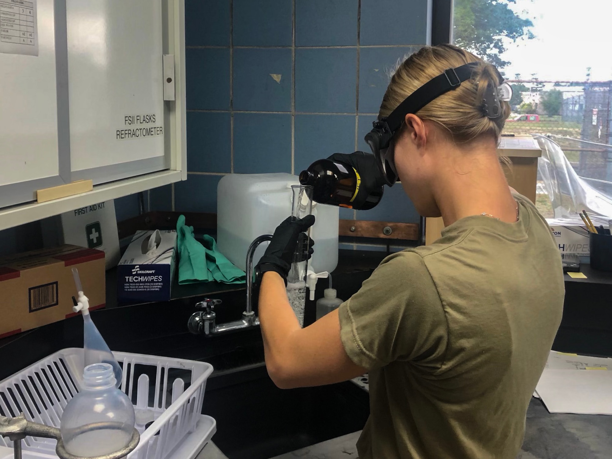 A photo of Tech. Sgt. Megan Atkinson performing a fuels icing inhibitor test.