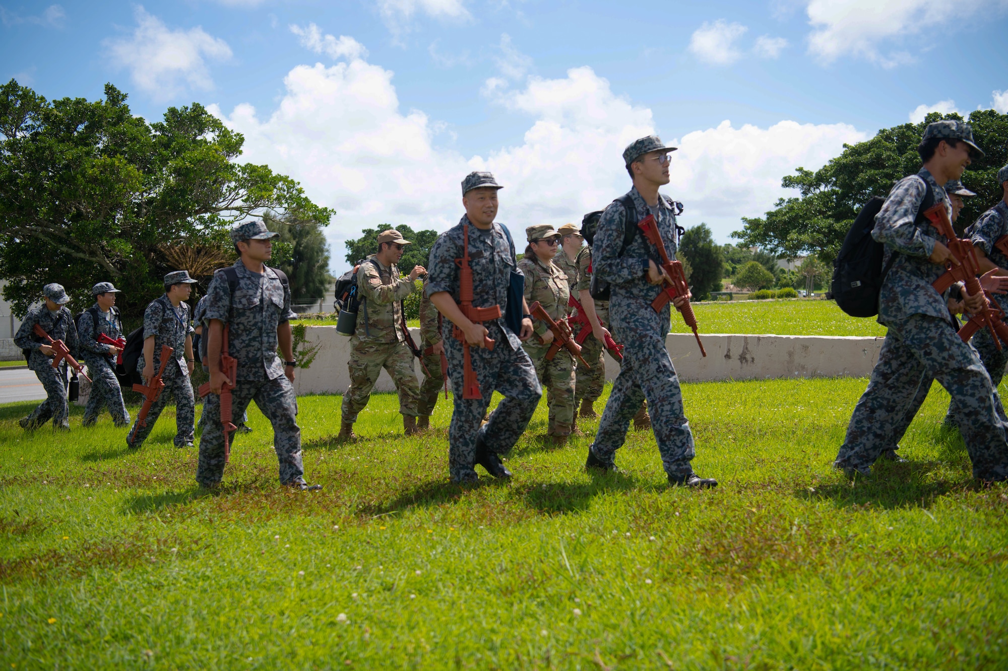 JASDF members walk with training rifles.