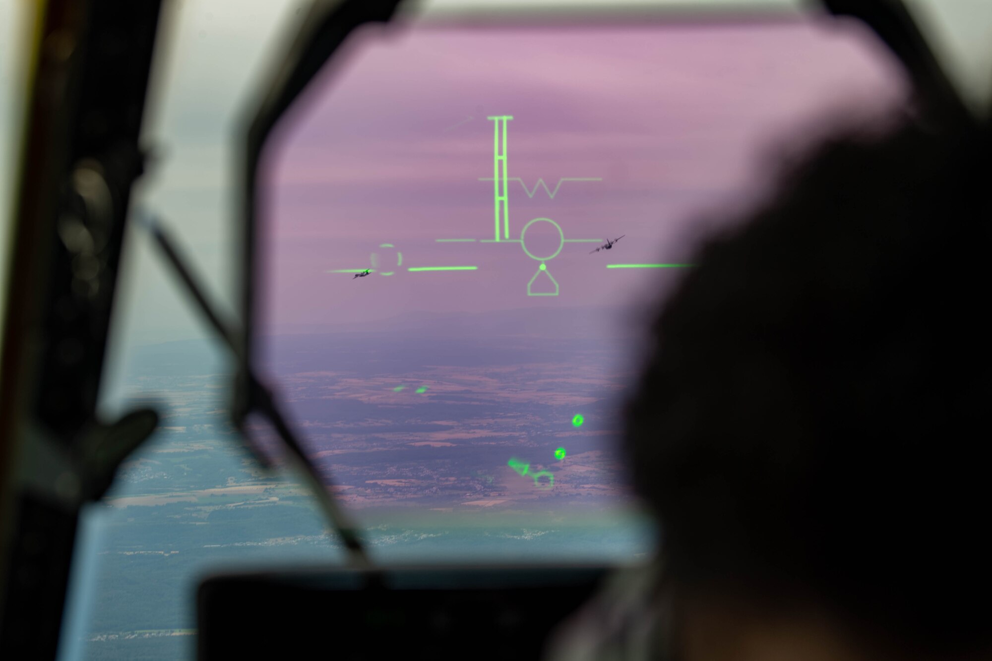 U.S. Air Force 1st Lt. Gabe Jenkins, 37th Airlift Squadron C-130J Super Hercules aircraft pilot, uses the head-up display while flying a C-130J during a large NATO interflight formation after departing Ramstein Air Base, Germany, at Ramstein AB, July 14, 2023.