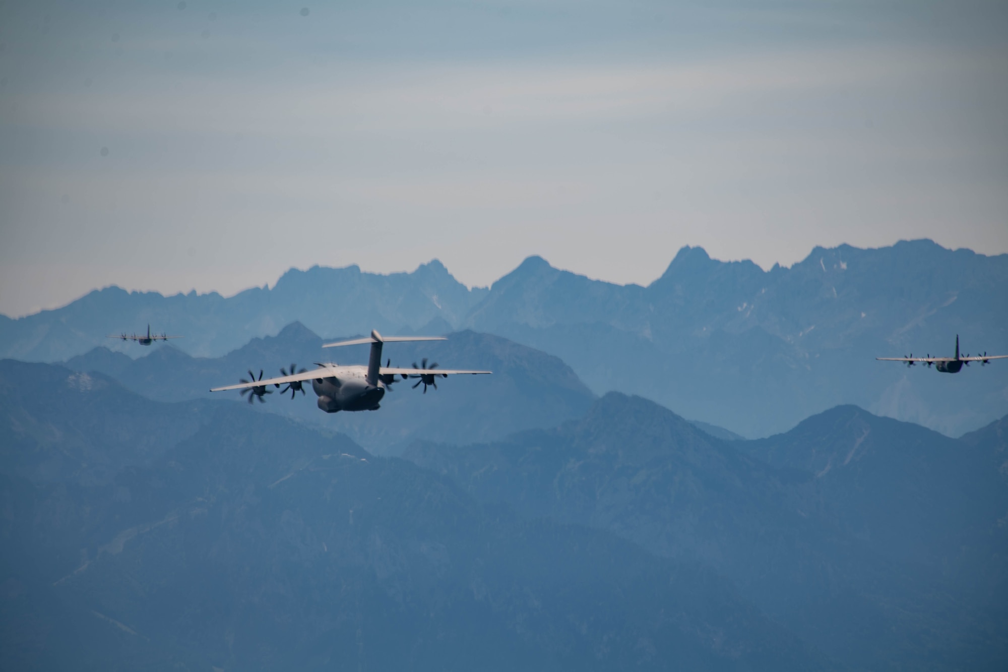 A German air force Airbus A400M Atlas aircraft flies with two U.S. Air Force C-130J Super Hercules aircraft, assigned to 37th Airlift Squadron at Ramstein Air Base, Germany, during a large NATO interfly formation after taking off from Ramstein AB, July 14, 2023.