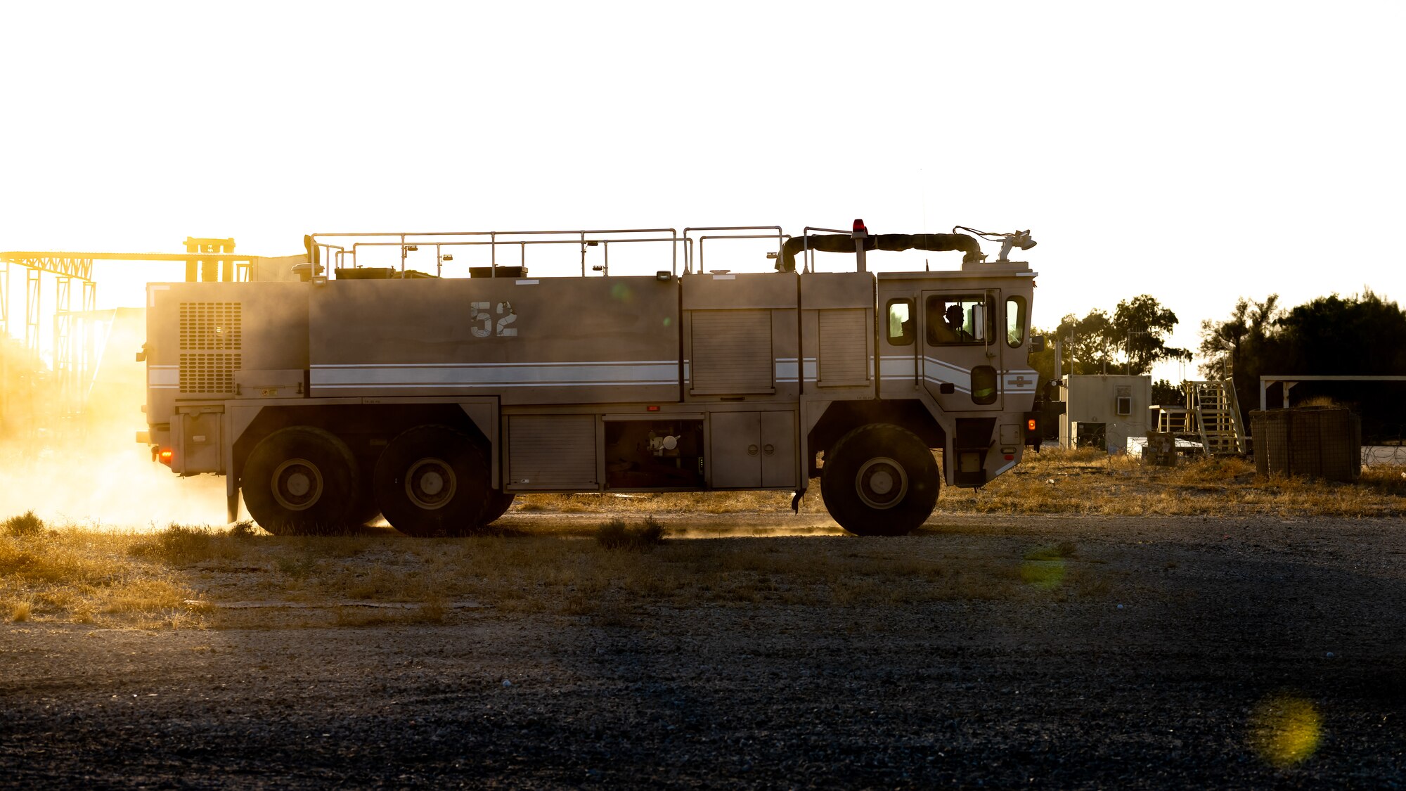 U.S. Air Force fire protection Airmen from the 386th Expeditionary Civil Engineer Squadron arrive on scene to a simulated aircraft accident during a medical response exercise at Ali Al Salem Air Base, Kuwait, July 17, 2023. This exercise tested the emergency response systems of U.S. and coalition forces, which allowed for a better understanding of how they can communicate and operate together in the event of a real-world emergency. (U.S. Air Force photo by Staff Sgt. Kevin Long)