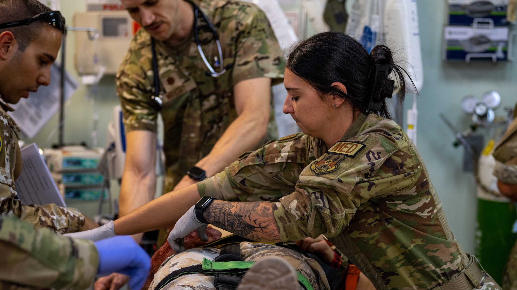 U.S. Air Force Airmen from the 386th Expeditionary Medical Squadron tend to the wounds of a victim from a simulated aircraft crash during a medical response exercise at Ali Al Salem Air Base, Kuwait, July 17, 2023. This exercise tested the emergency response systems of U.S. and coalition forces, which allowed for a better understanding of how they can communicate and operate together in the event of a real-world emergency. (U.S. Air Force photo by Staff Sgt. Kevin Long)