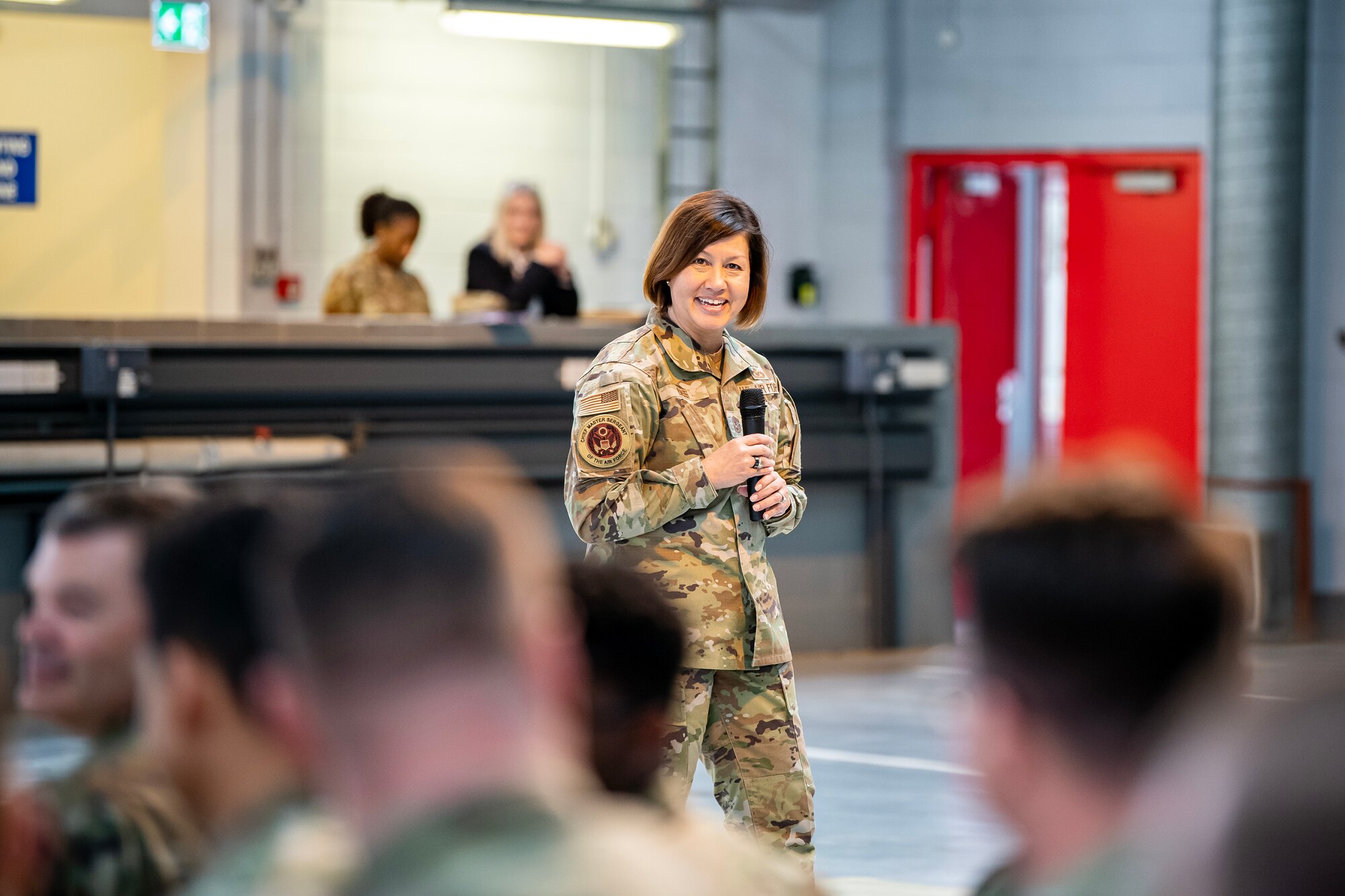 Chief Master Sgt. of the Air Force JoAnne S. Bass greets members from the 501st Combat Support Wing during an all-call at RAF Alconbury, England, July 20, 2023. The all-call covered the Air Force’s strategic priorities, the future of pay and benefits for Airmen and the importance of posturing for future warfighting operations. Additionally, the visit from CMSAF gave her the opportunity to speak with and recognize Airmen from across the 501 CSW. (U.S. Air Force photo by Staff Sgt. Eugene Oliver)