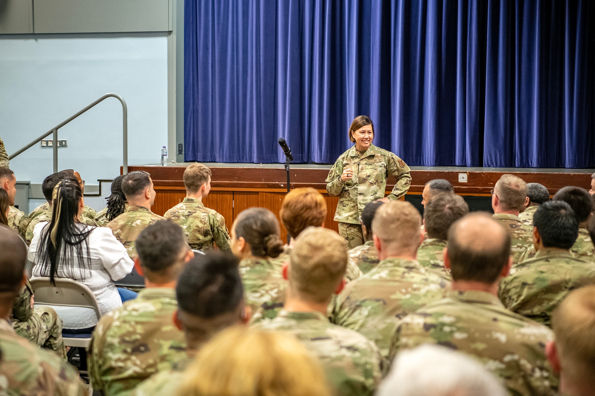 Chief Master Sgt. of the Air Force JoAnne S. Bass speaks about the future of the Air Force and its priorities with 501st Combat Support Wing members at RAF Croughton, England, July 12, 2023. The all-call covered the Air Force’s strategic priorities, the future of pay and benefits for Airmen and the importance of posturing for future warfighting operations. Additionally, the visit from CMSAF gave her the opportunity to speak with and recognize Airmen from across the 501 CSW. (U.S. Air Force photo by Staff Sgt. Eugene Oliver)