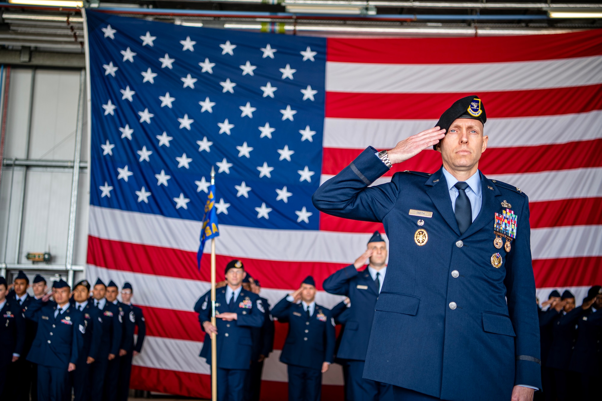 Airmen from the 501st Combat Support Wing salute during a change of command ceremony at RAF Fairford, England, July 18, 2023. During the ceremony, Col. Brian Filler relinquished command of the 501st CSW to Col. Dennis Phillips. (U.S. Air Force photo by Staff Sgt. Eugene Oliver)