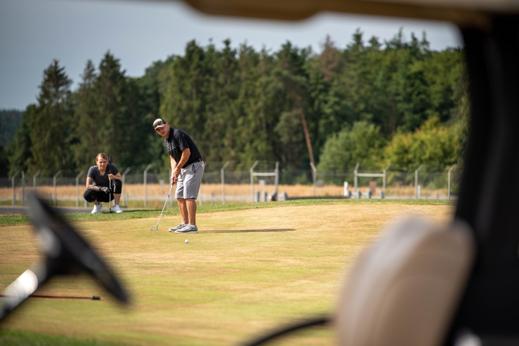 U.S. Air Force Master Sgt. Brian Wingo, 52nd Fighter Wing self-assessment program manager, putts during a golf tournament .