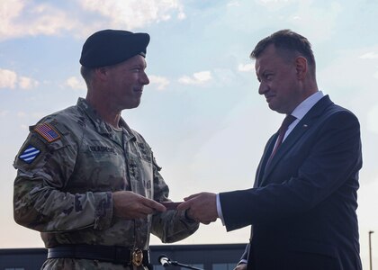 U.S. Army V Corps Commanding General Lt. Gen. John S. Kolasheski receives the Polish Armed Forces Gold Medal from Polish Minister of National Defense Mariusz Błaszczak during V Corps' Victory Honors ceremony July 18, 2023, Fort Knox, Kentucky. The event was a combined welcome and farewell ceremony, referred to as Victory Honors, with special guest Polish Minister of National Defense Mariusz Błaszczak, for V Corps’ deputy commanding generals at the V Corps Headquarters. (U.S. Army photo by Spc. Devin Klecan)