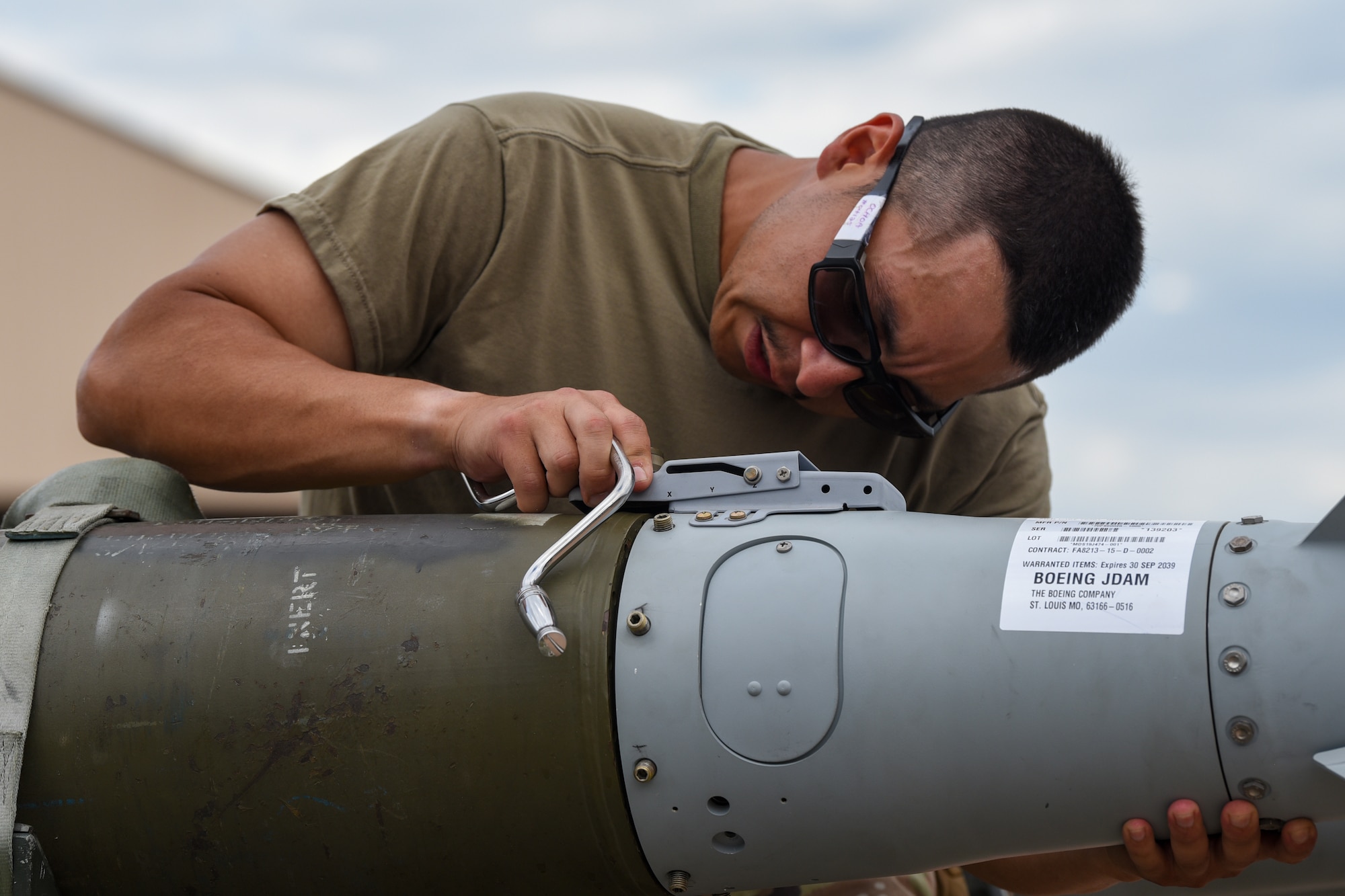 Airman First Class Nicholas Ochoa, 7th Munitions Squadron munitions technician, aligns the tail assembly on an inert Joint Direct Attack Munition during the Lone Star Challenge at Dyess Air Force Base, Texas, July 13, 2023. Two teams competed in various components which tested the abilities of Airmen from multiple squadrons in building, preparing and loading JDAMs into the B-1B Lancer. The event was designed to exercise real-world actions the 7th Bomb Wing would do if called for no notice missions.  (U.S. Air Force photo by Senior Airman Sophia Robello)