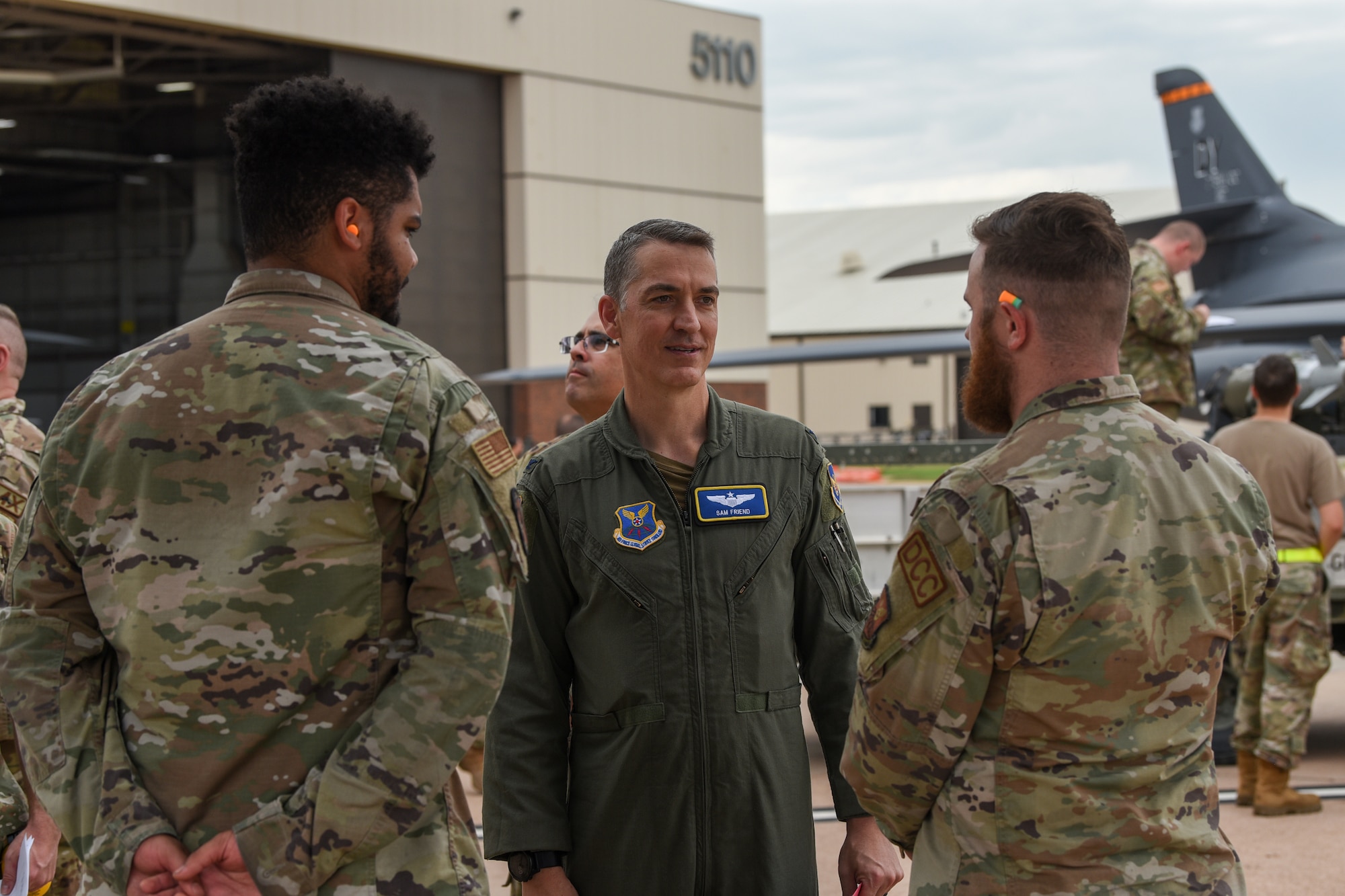 Senior Airman Lonnie Lewis and Staff Sgt. Tristan Austin, 7th Aircraft Maintenance Squadron crew chiefs, brief Col. Samuel Friend, 7th Bomb Wing vice commander, on the status and key facts of their aircraft during the Lone Star Challenge at Dyess Air Force Base, Texas, July 13, 2023. Two teams competed in various components which tested the abilities of Airmen from multiple squadrons in building, preparing and loading JDAMs into the B-1B Lancer. The event was designed to exercise real-world actions the 7th BW would do if called for no notice missions. (U.S. Air Force photo by Senior Airman Sophia Robello)