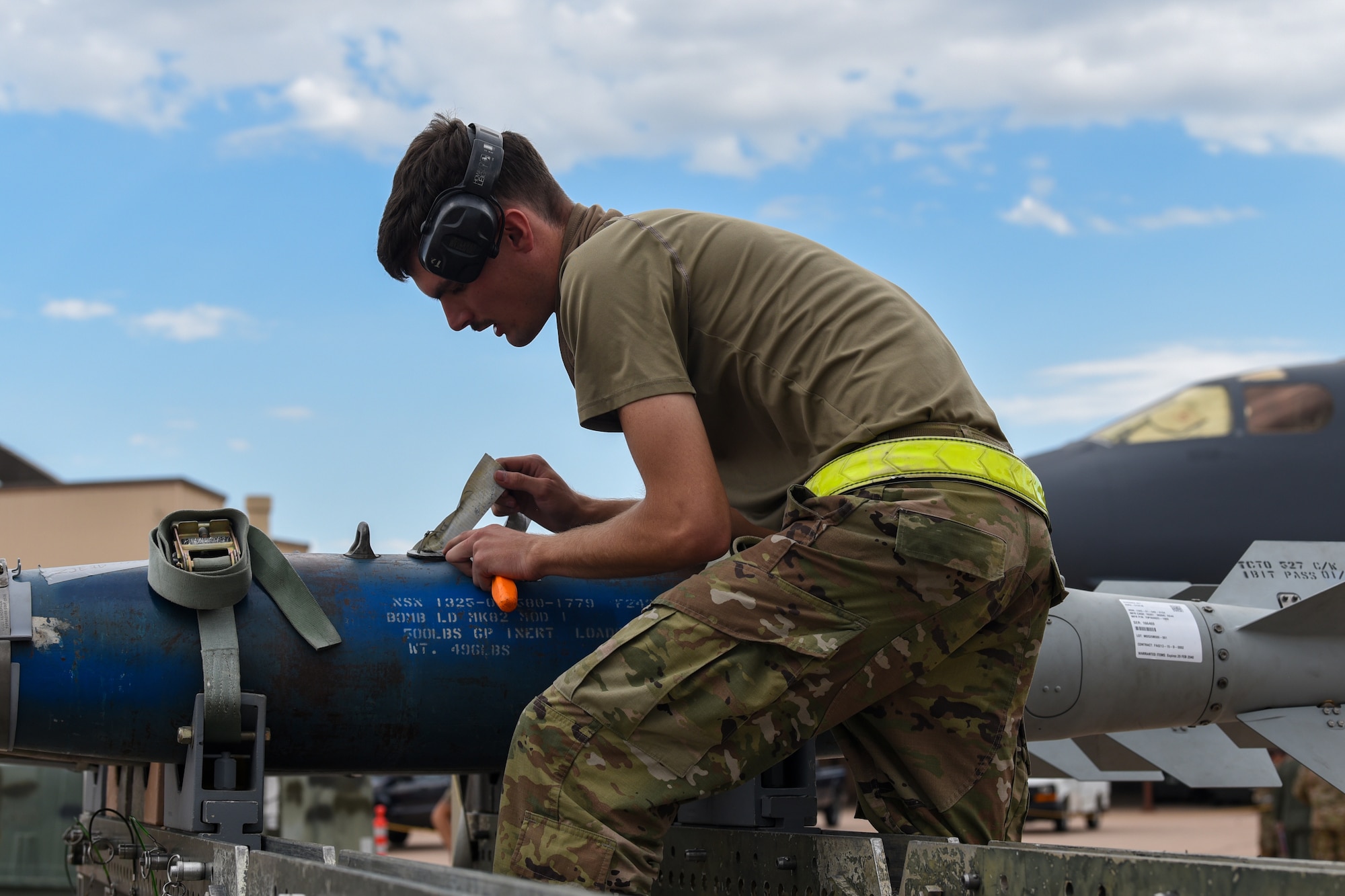 Senior Airman Phillip Crumley, 7th Munitions Squadron weapons load crew member, inspects the initiator of an inert Joint Direct Attack Munition during the Lone Star Challenge at Dyess Air Force Base, Texas, July 13, 2023. Two teams competed in various components which tested the abilities of Airmen from multiple squadrons in building, preparing and loading JDAMs into the B-1B Lancer. The event was designed to exercise real-world actions the 7th Bomb Wing would do if called for no notice missions. (U.S. Air Force photo by Senior Airman Sophia Robello)