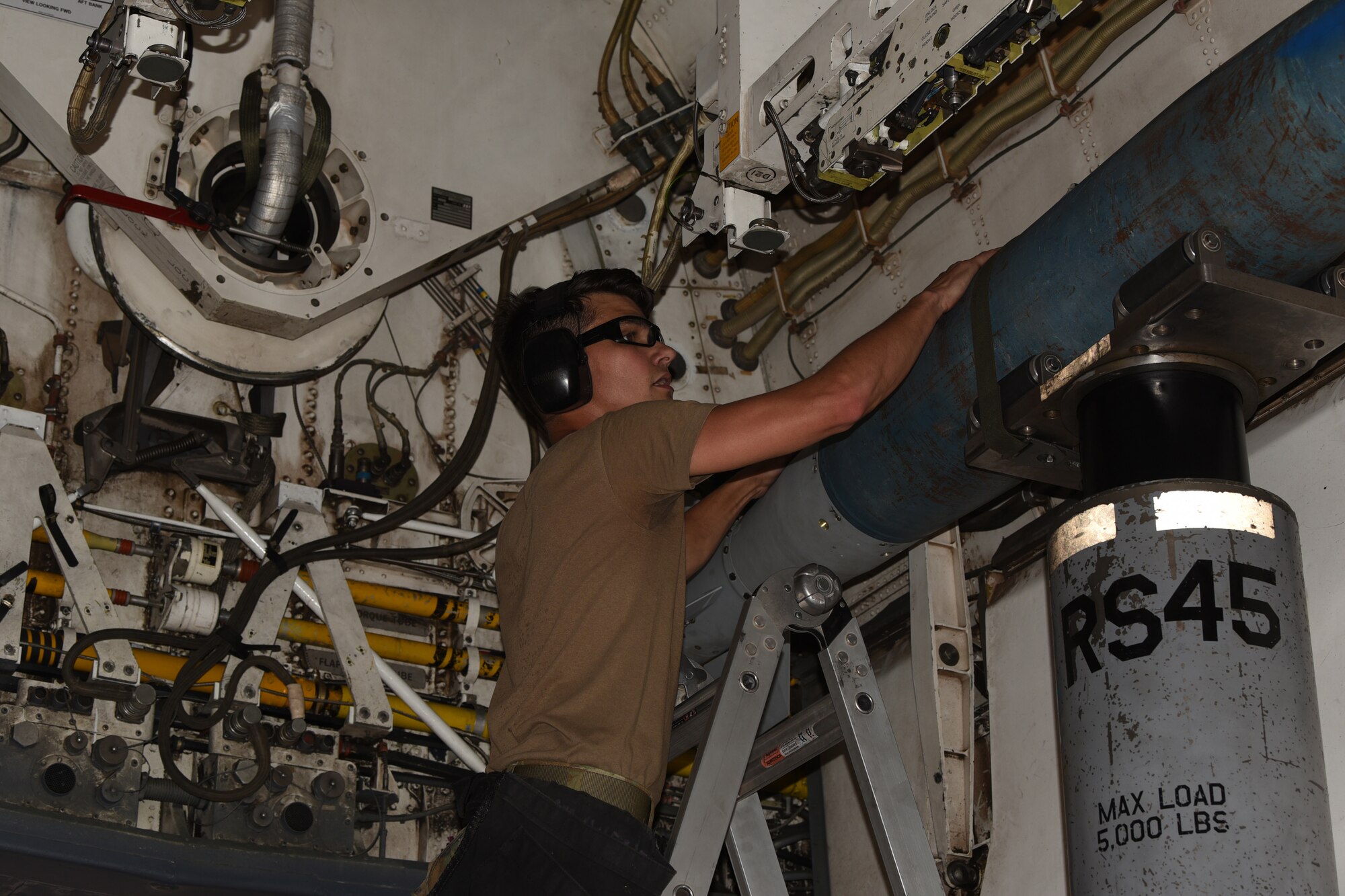 Senior Airman Jacob Arnold, 7th Munitions Squadron weapons load crew member, prepares to lock in an inert Joint Direct Attack Munition into a B-1B Lancer during the Lone Star Challenge at Dyess Air Force Base, Texas, July 13, 2023. Two teams competed in various components which tested the abilities of Airmen from multiple squadrons in building, preparing and loading JDAMs into the B-1B. The event was designed to exercise real-world actions the 7th Bomb Wing would do if called for no notice missions. (U.S. Air Force photo by Senior Airman Sophia Robello)