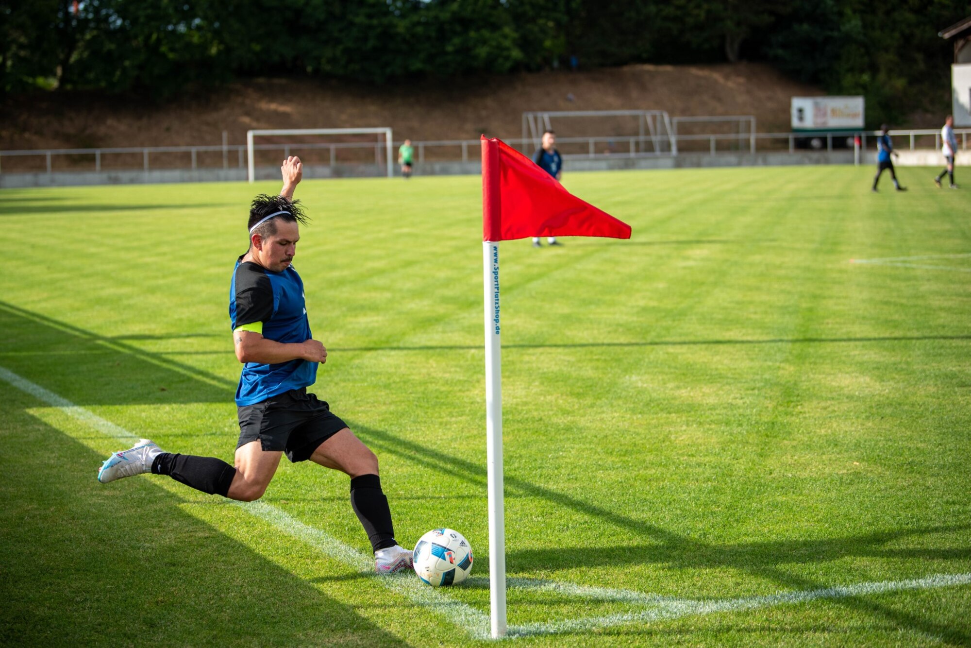 A Spangdahlem Saber makes a corner kick during a local soccer match in Binsfeld, Germany, July 15, 2023.