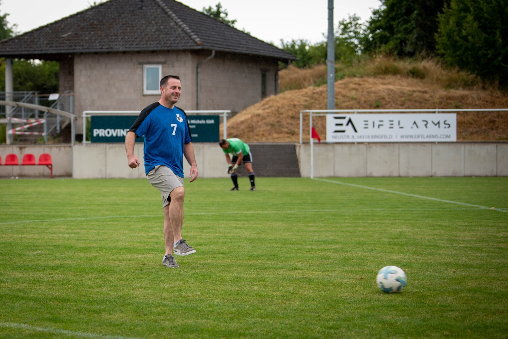 U.S. Air Force Col. Kevin Crofton, 52nd Fighter Wing commander, kicks off a soccer match between the Spangdahlem Air Base and local Binsfeld soccer teams in Binsfield, Germany, July 15, 2023.