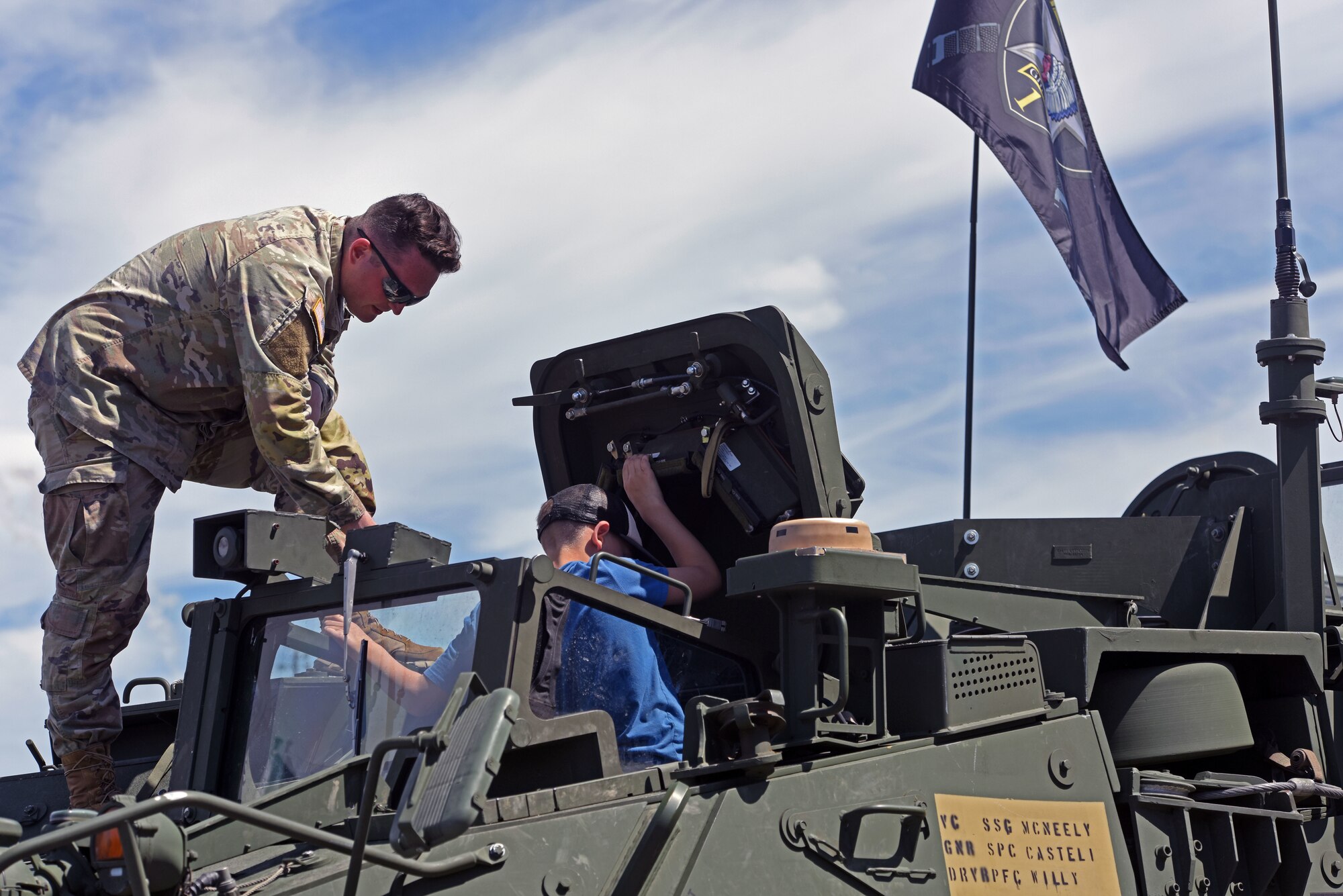 A U.S. Army Soldier gives a child a tour of the Stryker Mortar Carrier vehicle during the Joint Base Lewis-McChord Airshow and Warrior Expo at JBLM, Washington, July 16, 2023. The mission of the JAWE is to foster goodwill to educate and familiarize attendees with the people, mission, and equipment of the Air Force, Army, and other Armed Services while continuing to provide installation-wide mission support. (U.S. Air Force photo by Staff Sgt. Zoe Thacker)