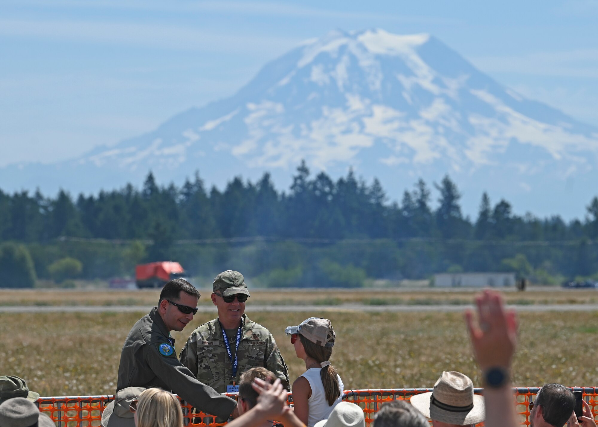U.S. Air Force Col. Sergio Anaya, left, 62d Airlift Wing commander, and Chief Master Sgt. Timothey Hodgin, 62d AW command chief, interact with attendees of the Joint Base Lewis-McChord Airshow and Warrior Expo at JBLM, Washington, July 16, 2023. The mission of the JAWE is to foster goodwill to educate and familiarize attendees with the people, mission, and equipment of the Air Force, Army, and other Armed Services while continuing to provide installation-wide mission support. (U.S. Air Force photo by Senior Airman Callie Norton)