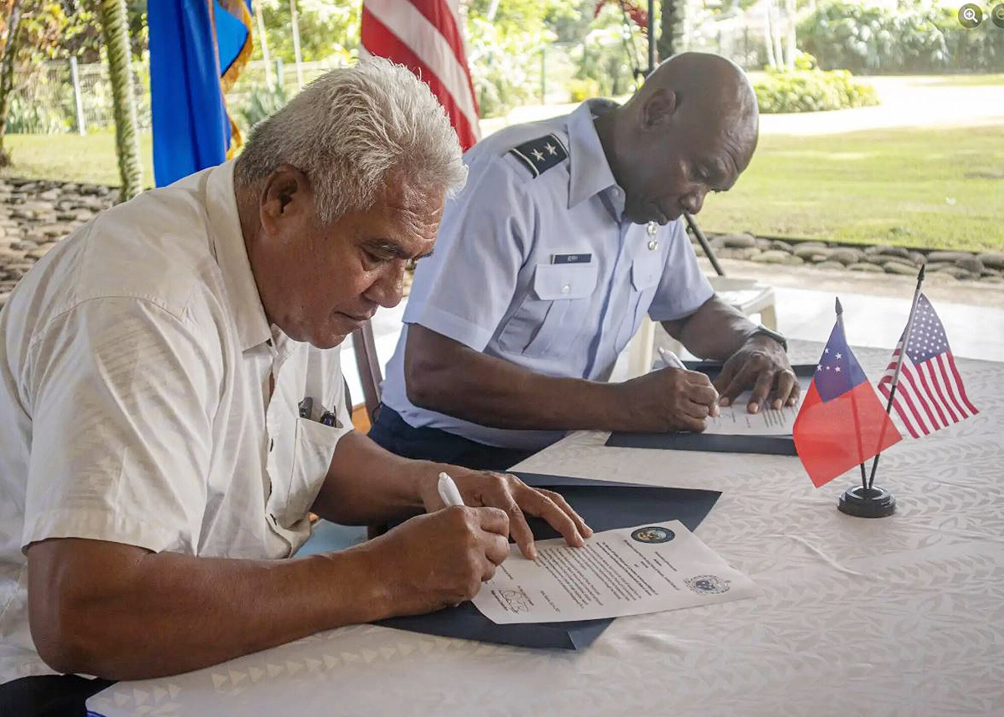 The Honorable Faualo Harry Schuster, the Government of Samoa’s Minister of Police, Prisons and Corrections Services, left, and Nevada Guard Adjutant General Maj. Gen. Ondra Berry sign the Declaration of Partnership between the Nevada National Guard and the Government of Samoa on July 6 in Apia, Samoa.