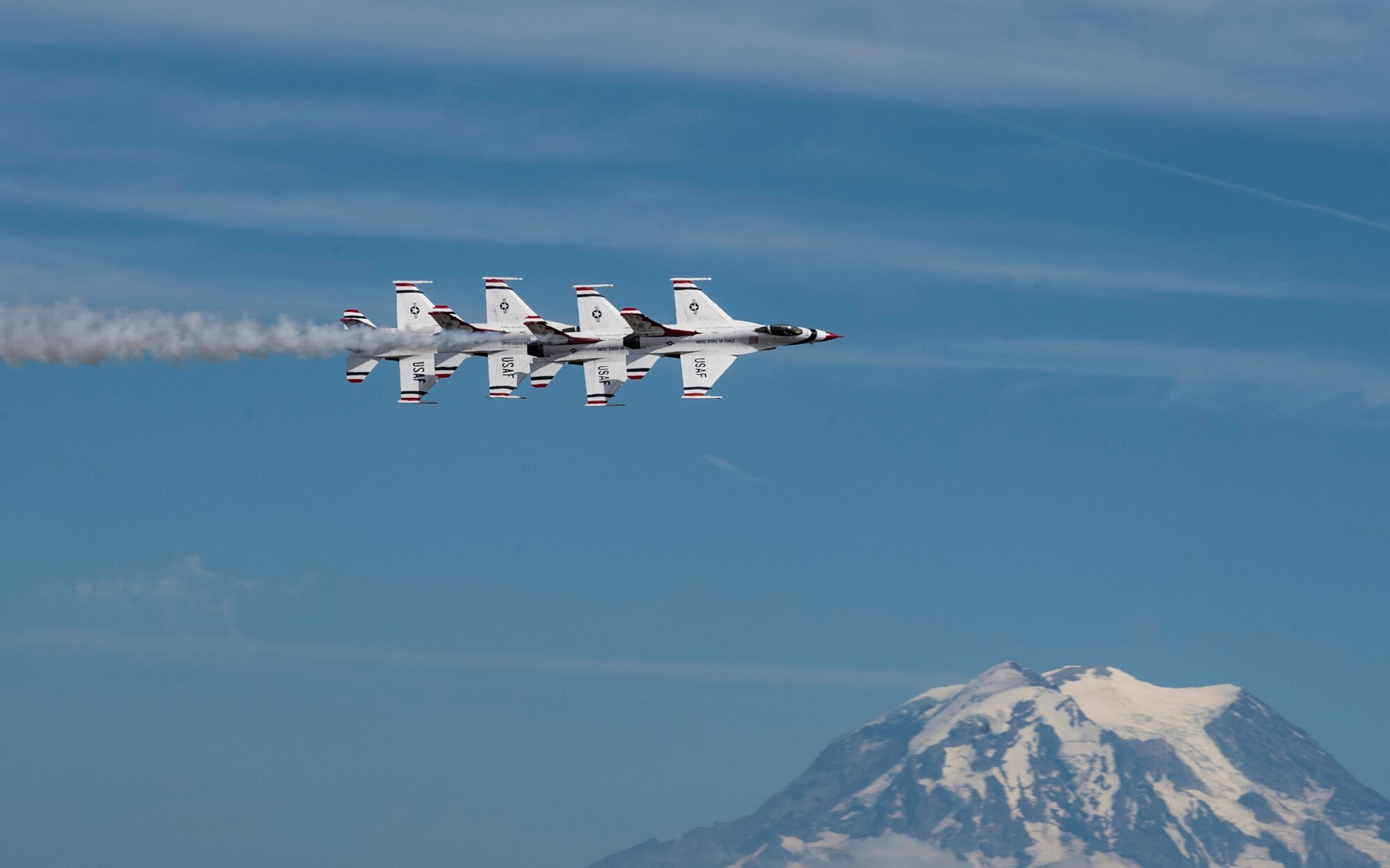 The U.S. Air Force Air Demonstration Squadron “Thunderbirds” #1-4 fly F-16 Fighting Falcon aircraft in a formation above the McChord Field flightline while performing during the Joint Base Lewis-McChord Airshow and Warrior Expo at JBLM, Washington, July 16, 2023. The mission of the JAWE is to foster goodwill to educate and familiarize attendees with the people, mission, and equipment of the Air Force, Army, and other Armed Services while continuing to provide installation-wide mission support. The Thunderbirds were one of the JAWE’s premier acts and were joined by aerial demonstrations from the C-17 West Coast Demonstration Team, Tora! Tora! Tora! and many more. (U.S. Air Force photo by Staff Sgt. Rachel Williams)
