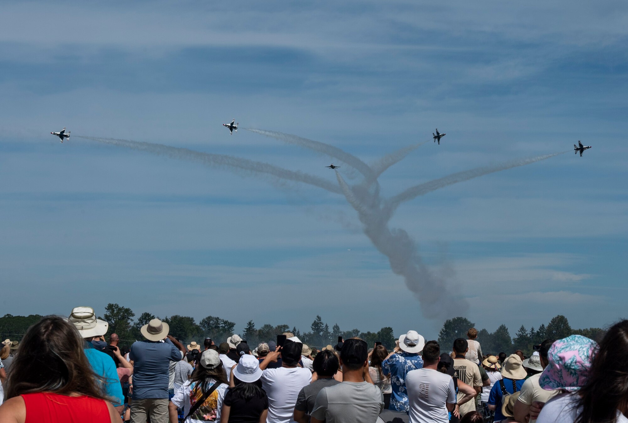 Spectators at the Joint Base Lewis-McChord Airshow and Warrior Expo watch the U.S. Air Force Air Demonstration Squadron “Thunderbirds” perform over the McChord Field flightline at JBLM, Washington, July 16, 2023. The mission of the JAWE is to foster goodwill to educate and familiarize attendees with the people, mission, and equipment of the Air Force, Army, and other Armed Services while continuing to provide installation-wide mission support. The Thunderbirds were one of the JAWE’s premier acts and were joined by aerial demonstrations from the C-17 West Coast Demonstration Team, Tora! Tora! Tora! and many more. (U.S. Air Force photo by Staff Sgt. Rachel Williams)