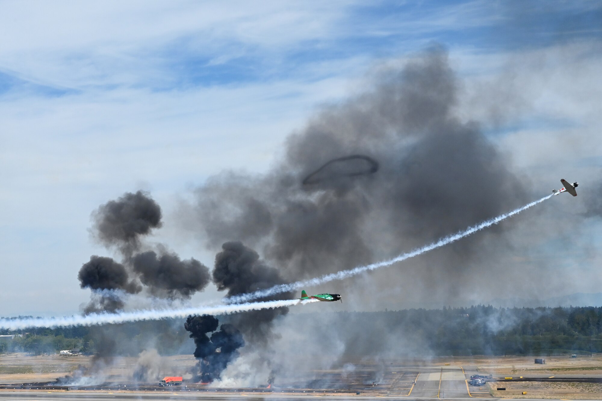 Tora! Tora! Tora! warbird performers fly above the McChord Field flightline during the Joint Base Lewis-McChord Airshow and Warrior Expo at JBLM, Washington, July 16, 2023. The mission of the JAWE was to foster goodwill to educate and familiarize attendees with the people, mission, and equipment of the Air Force, Army, and other Armed Services while continuing to provide installation-wide mission support. (U.S. Air Force photo by Senior Airman Colleen Anthony)