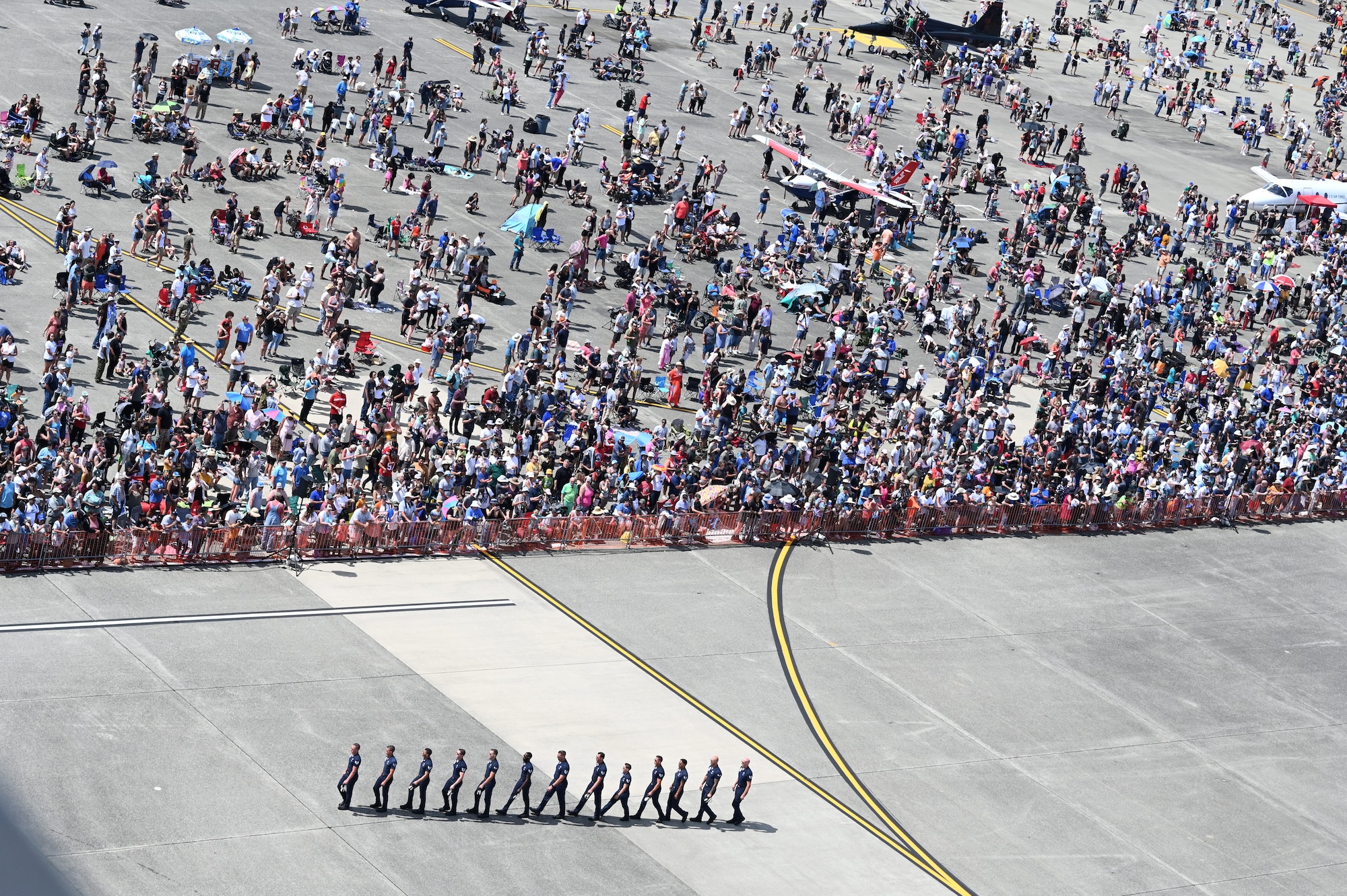 Spectators at the Joint Base Lewis-McChord Airshow and Warrior Expo watch the U.S. Air Force Air Demonstration Squadron “Thunderbirds” maintenance crew perform at JBLM, Washington, July 16, 2023. The mission of the JAWE was to foster goodwill to educate and familiarize attendees with the people, mission, and equipment of the Air Force, Army, and other Armed Services while continuing to provide installation-wide mission support. The Thunderbirds were one of the JAWE’s premier acts and were joined by aerial demonstrations from the C-17 West Coast Demonstration Team, Tora! Tora! Tora! and many more. (U.S. Air Force photo by Senior Airman Colleen Anthony)