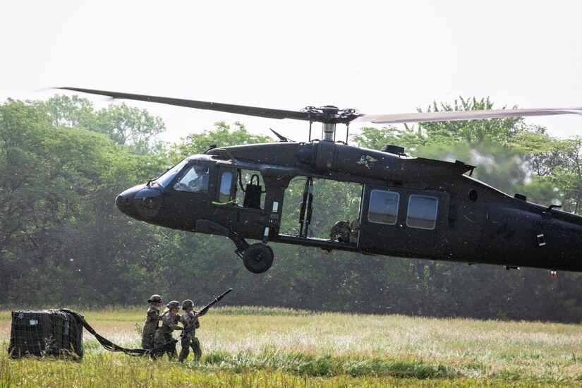 Soldiers with Company A, 628th Aviation Support Battalion, Pennsylvania Army National Guard, conduct sling-load operations with a UH-60 Black Hawk operated by Soldiers with Company C, 2nd Battalion, 147th Assault Helicopter Battalion, Iowa Army National Guard, at Camp Dodge in Johnston, Iowa, June 15, 2023.