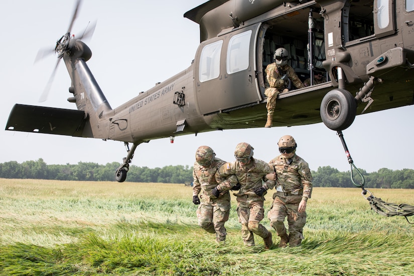 Soldiers with Company A, 628th Aviation Support Battalion, Pennsylvania Army National Guard, assisted by Sgt. Dylan Siler, cadre at the Army Sustainment Training Center, conduct sling-load operations with a UH-60 Black Hawk operated by Soldiers with Company C, 2nd Battalion, 147th Assault Helicopter Battalion, Iowa Army National Guard, at Camp Dodge in Johnston, Iowa, June 15, 2023.