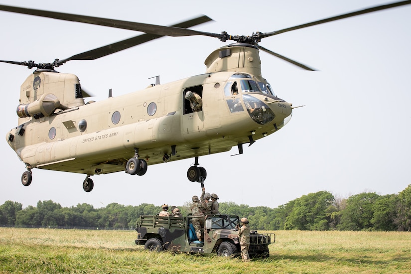 Soldiers with Company A, 628th Aviation Support Battalion, Pennsylvania Army National Guard, conduct sling-load operations with a CH-47F Chinook helicopter operated by Soldiers with Company B, 2nd Battalion, 211th General Support Aviation Battalion, Iowa Army National Guard, at Camp Dodge in Johnston, Iowa, June 15, 2023.