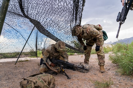 U.S. Army Sgt. 1st Class Tyler Townsend, a platoon sergeant assigned to the 549th Military Police Company, observes Spc. DeAndre Swinson, a military police gunner, also assigned to the 549th Military Police Company, during a no-notice Emergency Deployment Readiness Exercise, July 11. The U.S. Army North and XVIII ABN activated subordinate units to participate in a no-notice Emergency Deployment Readiness Exercise from July 10 - 15 to validate global response and readiness. The use of EDREs also assesses the unit’s home-station support procedures to ensure the Army can rapidly deploy to support America’s national security interests. (U.S. Army Photo by Bethany Huff)