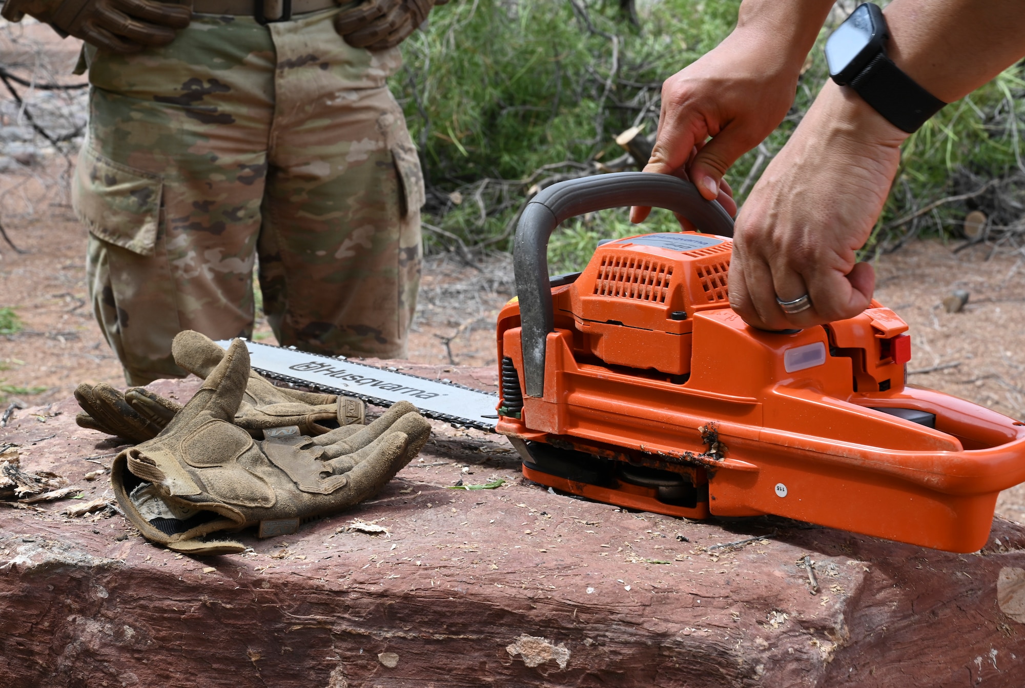 U.S. Air Force Tech. Sgt. Alonzo Marquez, 49th Civil Engineer Squadron pavements and construction equipment noncommissioned officer in charge, prepares chainsaw to remove debris from fallen tree at Holloman Air Force Base, New Mexico, June 29, 2023. The 49th CES “Dirt Boyz” Airmen are responsible for maintaining Holloman’s infrastructure by using a variety of tools to complete construction projects. (U.S. Air Force photo by Airman 1st Class Michelle Ferrari)