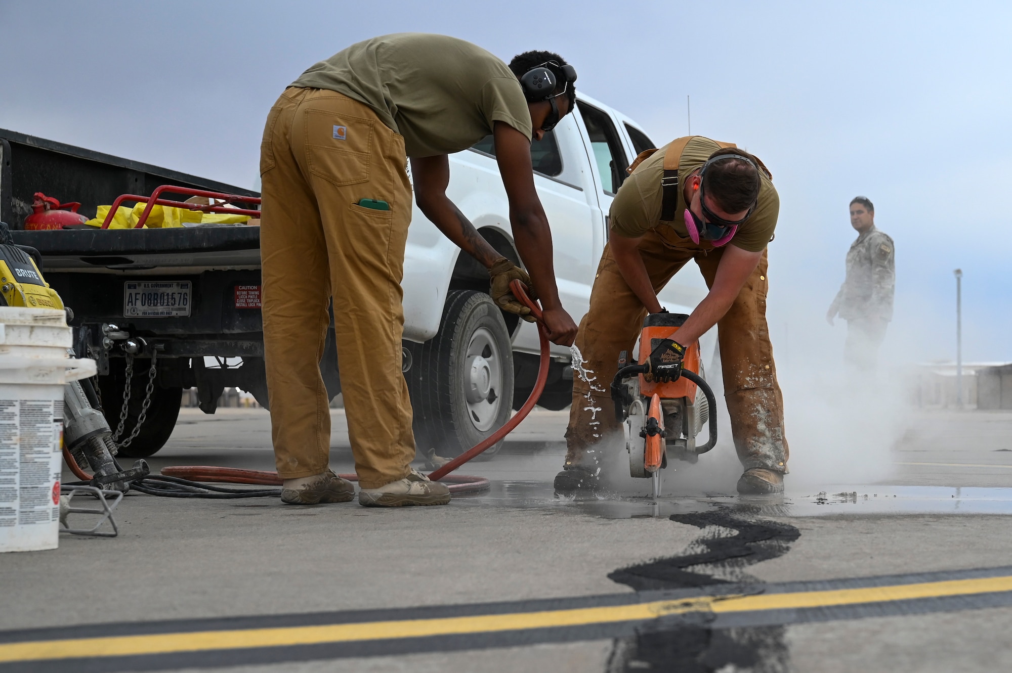 U.S. Air Force Senior Airman Jacquez Craddieth, left, and Senior Airman Eric Wheeler, 49th Civil Engineer Squadron pavement and construction equipment journeymen, utilize a K-12 concrete saw to repair a runway at Holloman Air Force Base, New Mexico, June 30, 2023. The 49th CES “Dirt Boyz” Airmen are responsible for maintaining Holloman’s infrastructure by using a variety of tools to complete construction projects. (U.S. Air Force photo by Airman 1st Class Michelle Ferrari)
